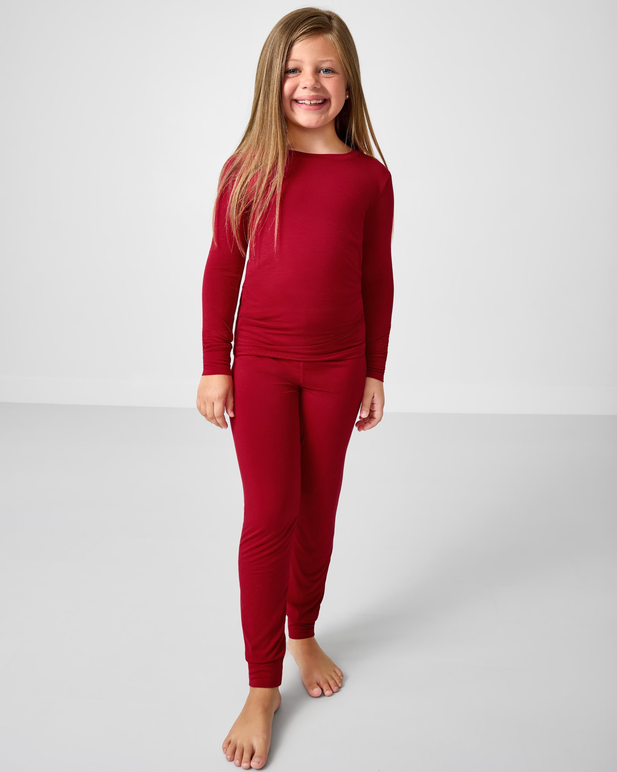 Girl wearing the Holiday Red Two-Piece Pajama Set