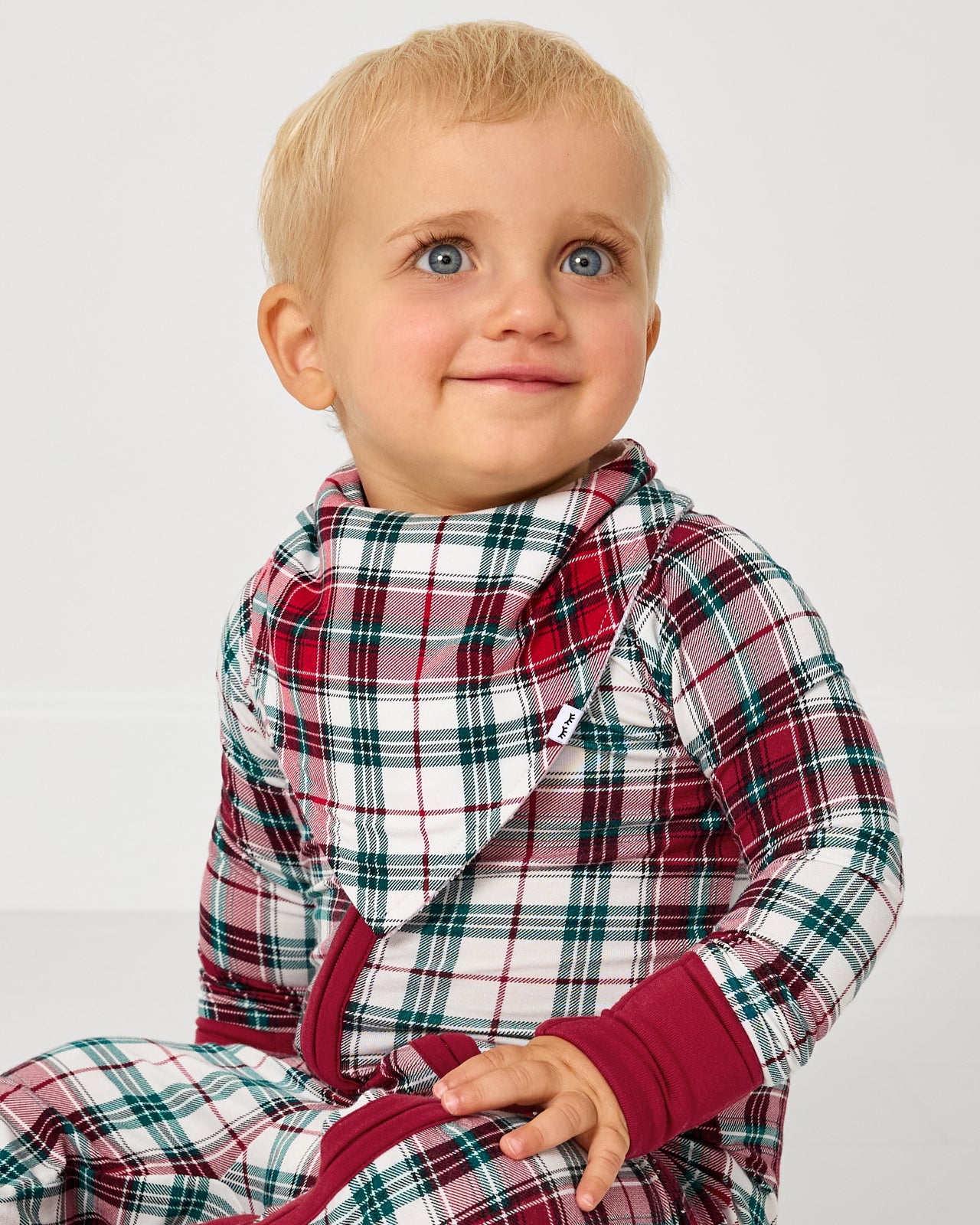 Baby wearing the Holly Plaid Bandana Bib