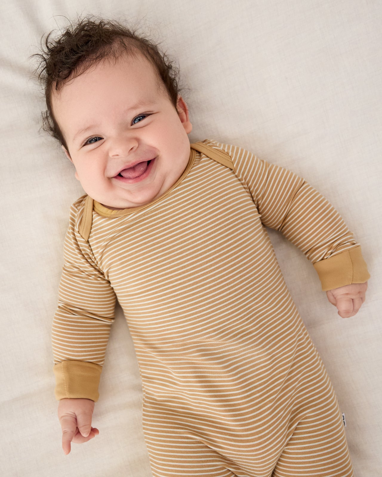 Close up of newborn wearing the Hazelwood Stripe Crescent Zippy