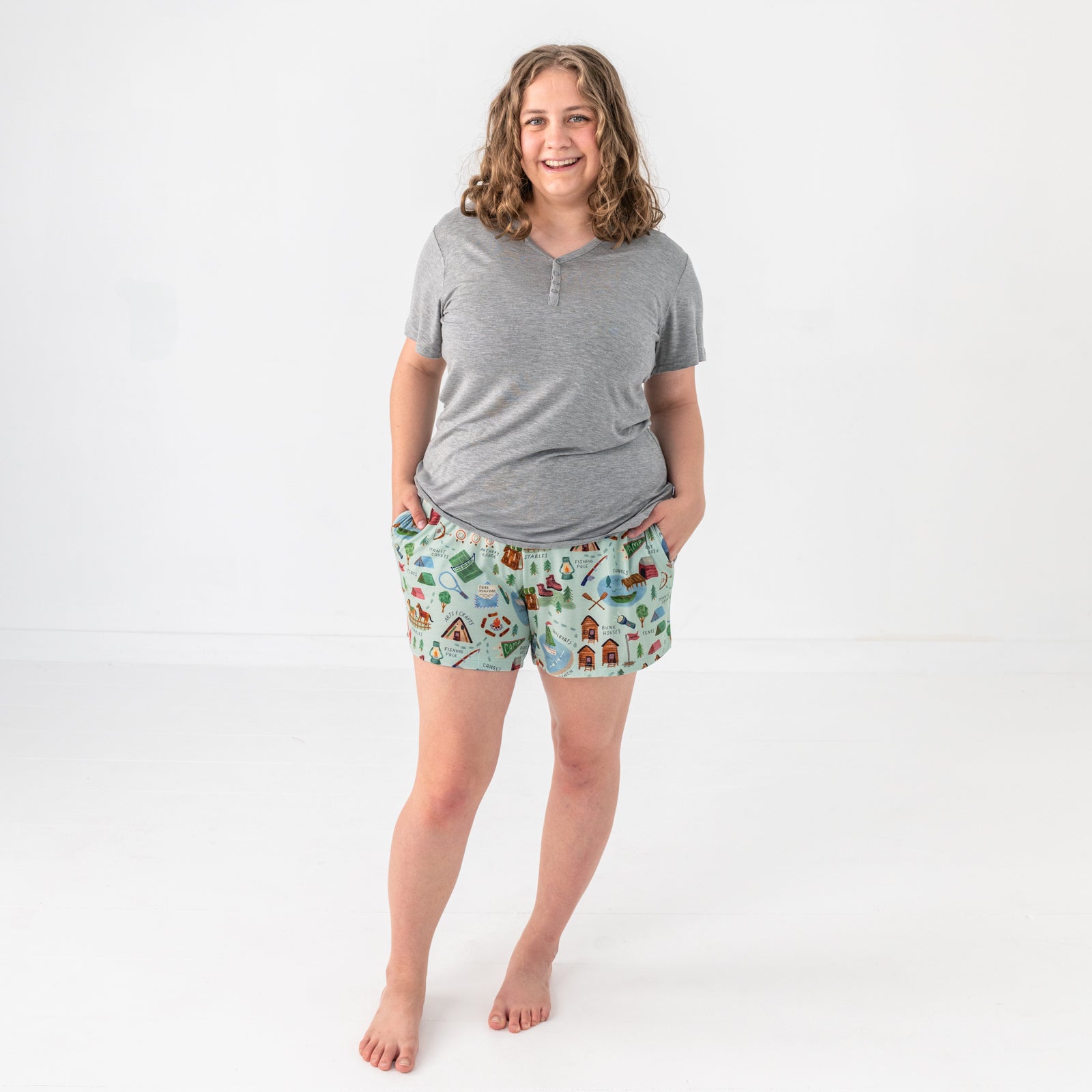 Standing woman wearing the Camp Sleepies Pajama Shorts with a Heather Gray Top