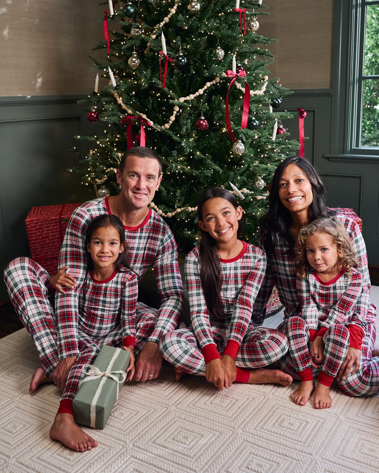 Family of five wearing Holly Plaid pajamas