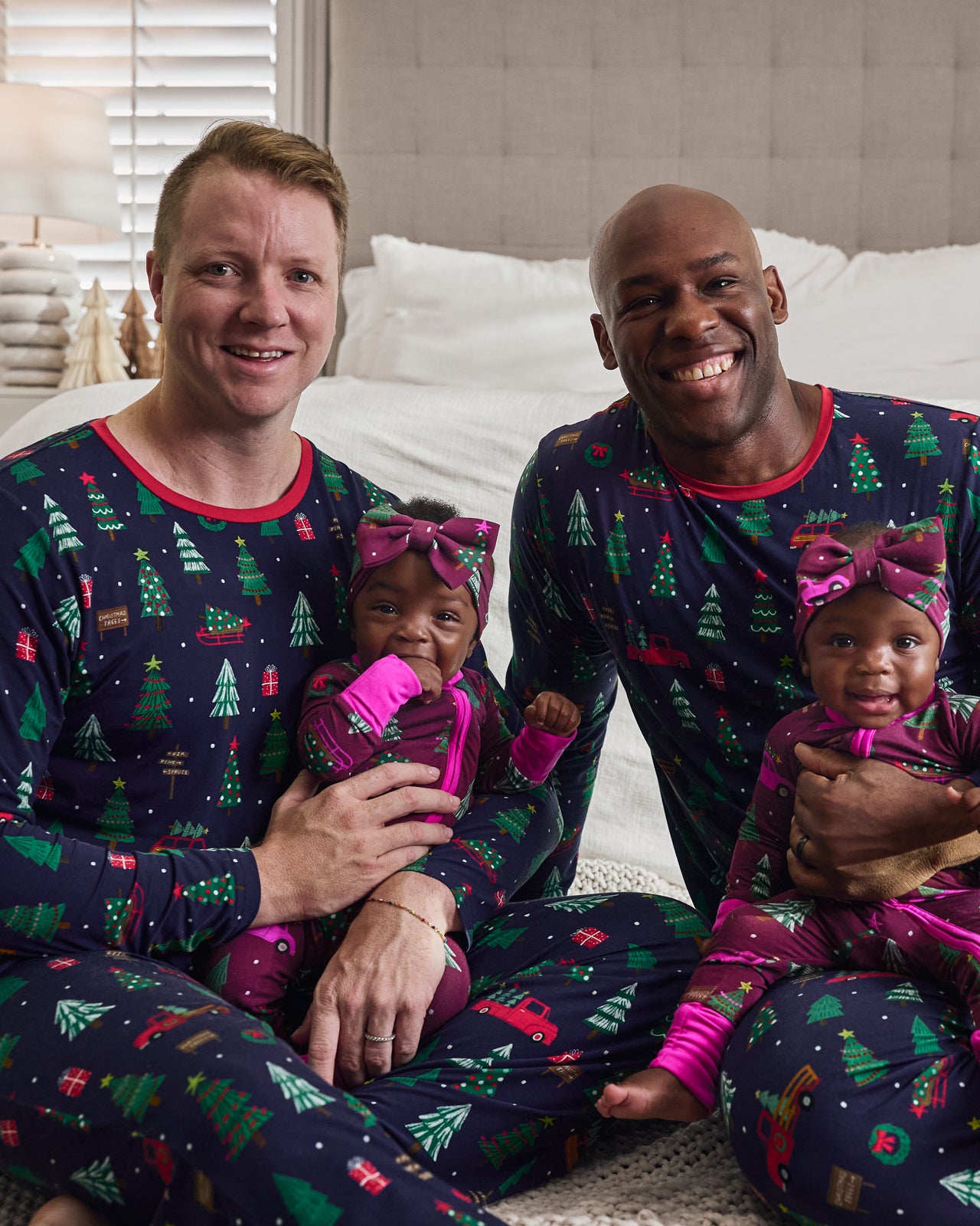 Family of four wearing matching Navy and Cranberry Tree Traffic pajamas