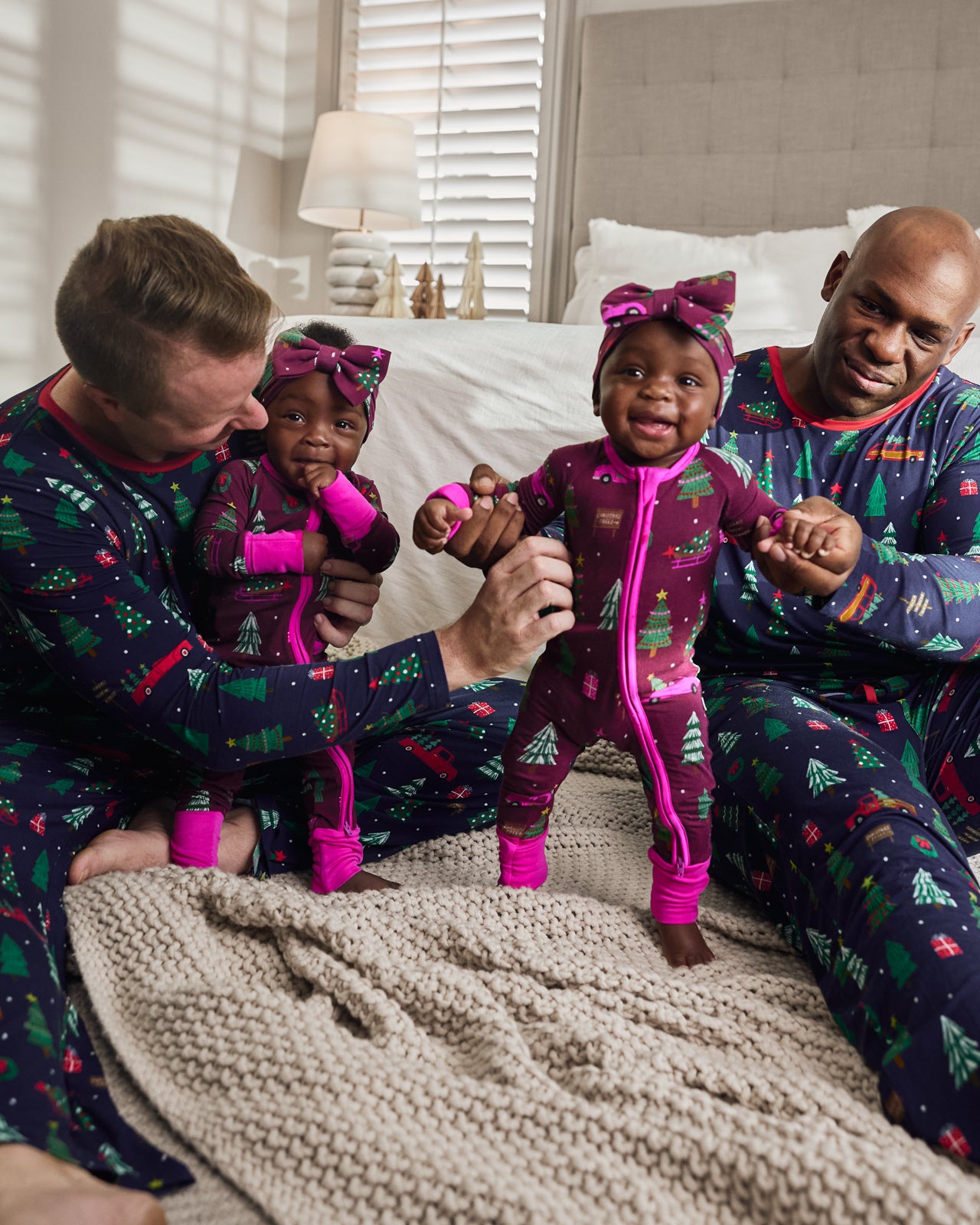 Family of four wearing matching Tree Traffic holiday themed Pajamas