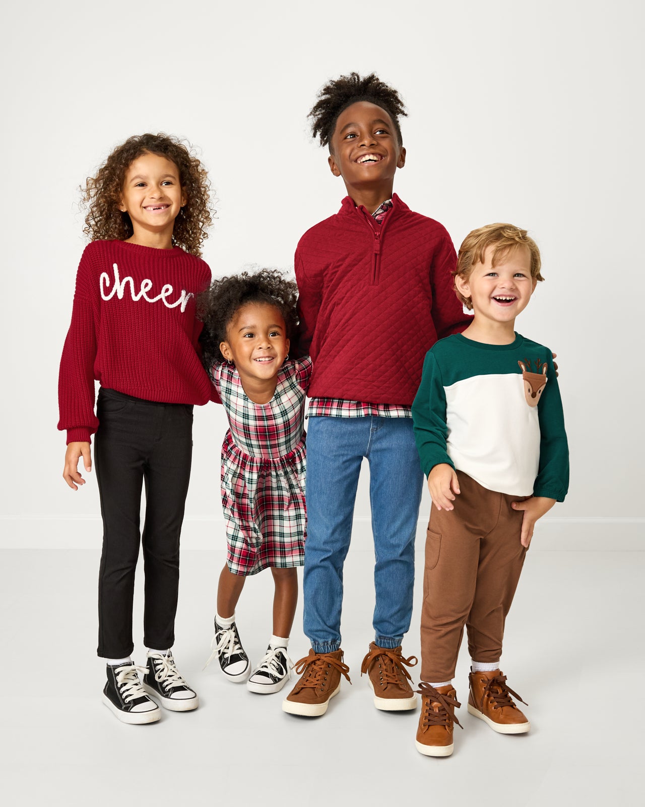 Group of four children wearing styles from the Holiday Play Capsule