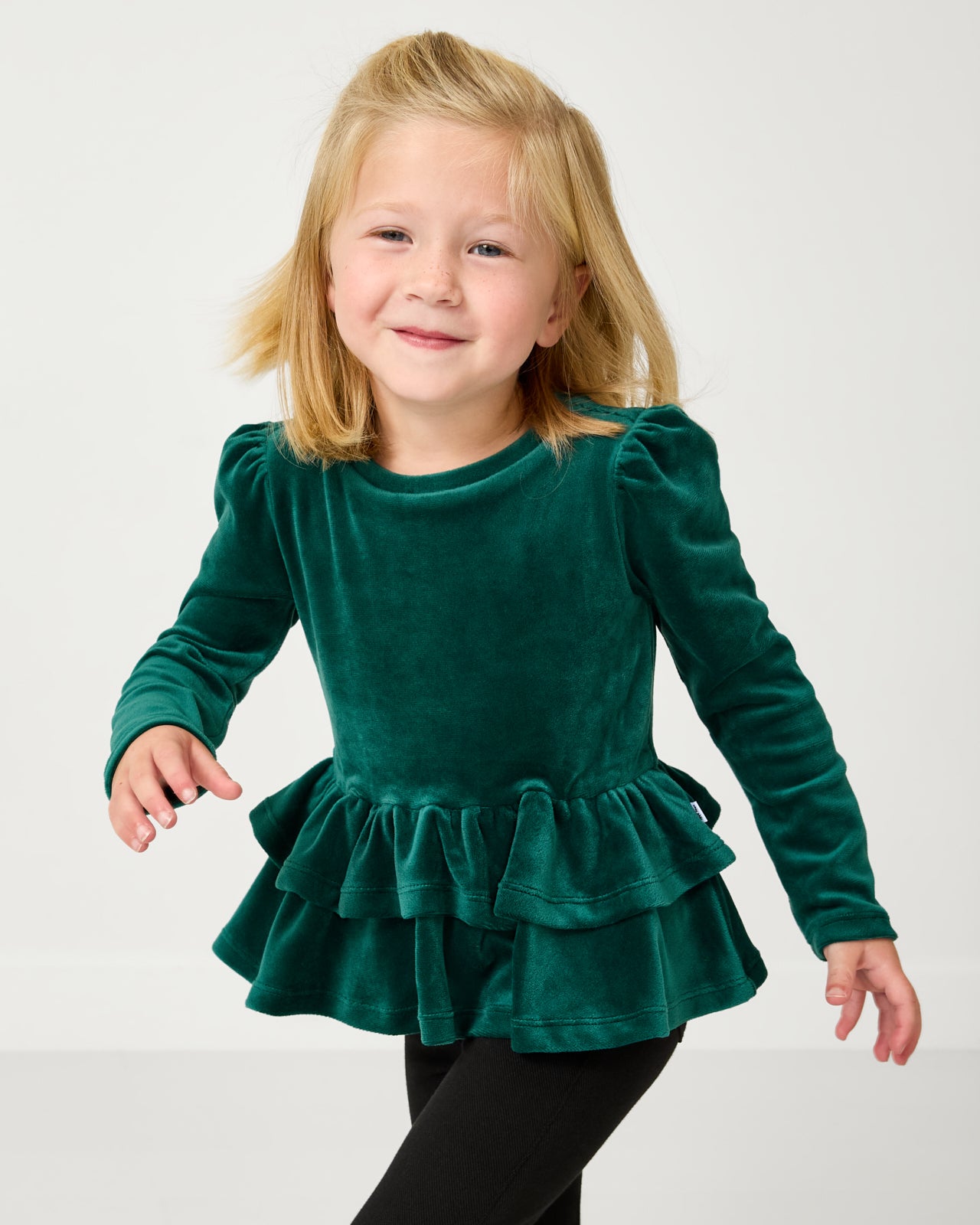 Close up of child wearing the Emerald Velvet Tiered Peplum Top