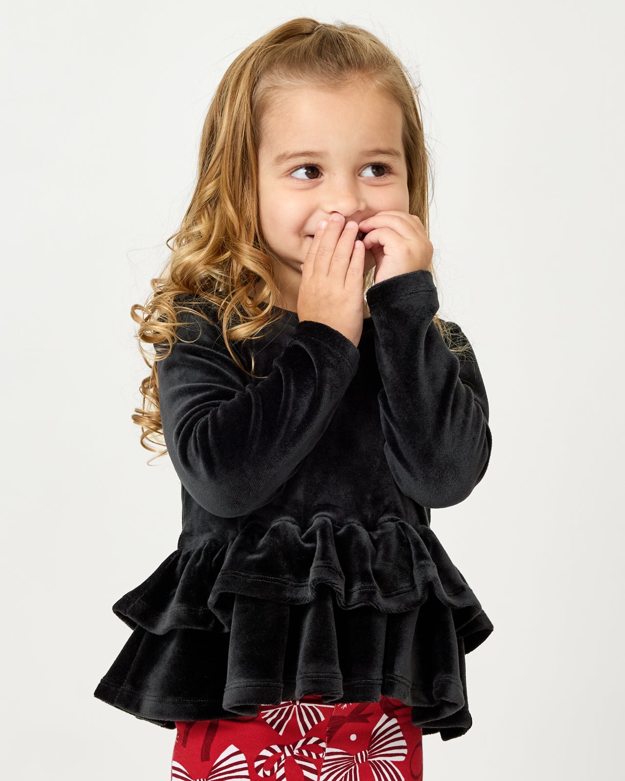 Close up of girl wearing the Black Velvet Tiered Peplum Top