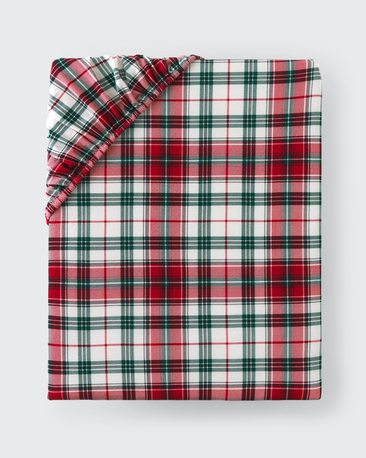 Flat lay of the Holly Plaid Fitted Crib Sheet