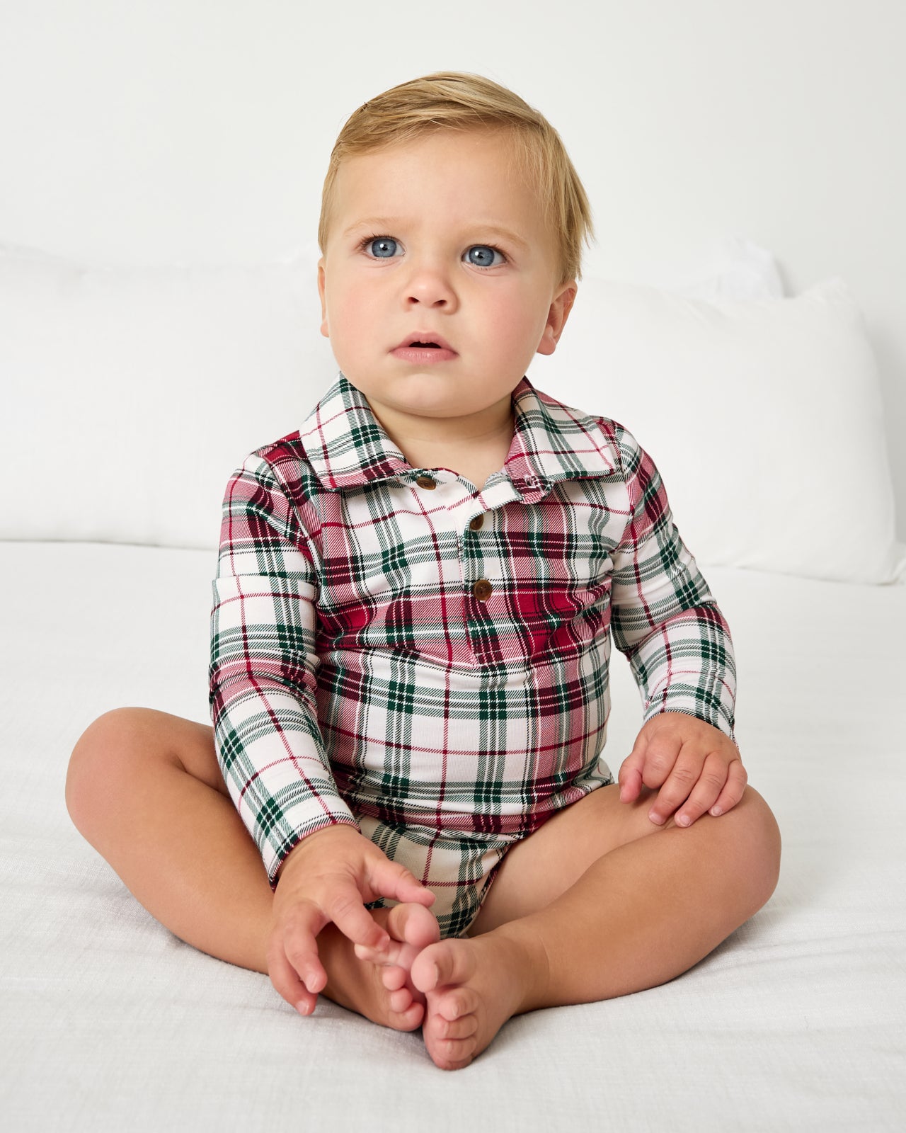 Sitting baby wearing the Holly Plaid Polo Bodysuit