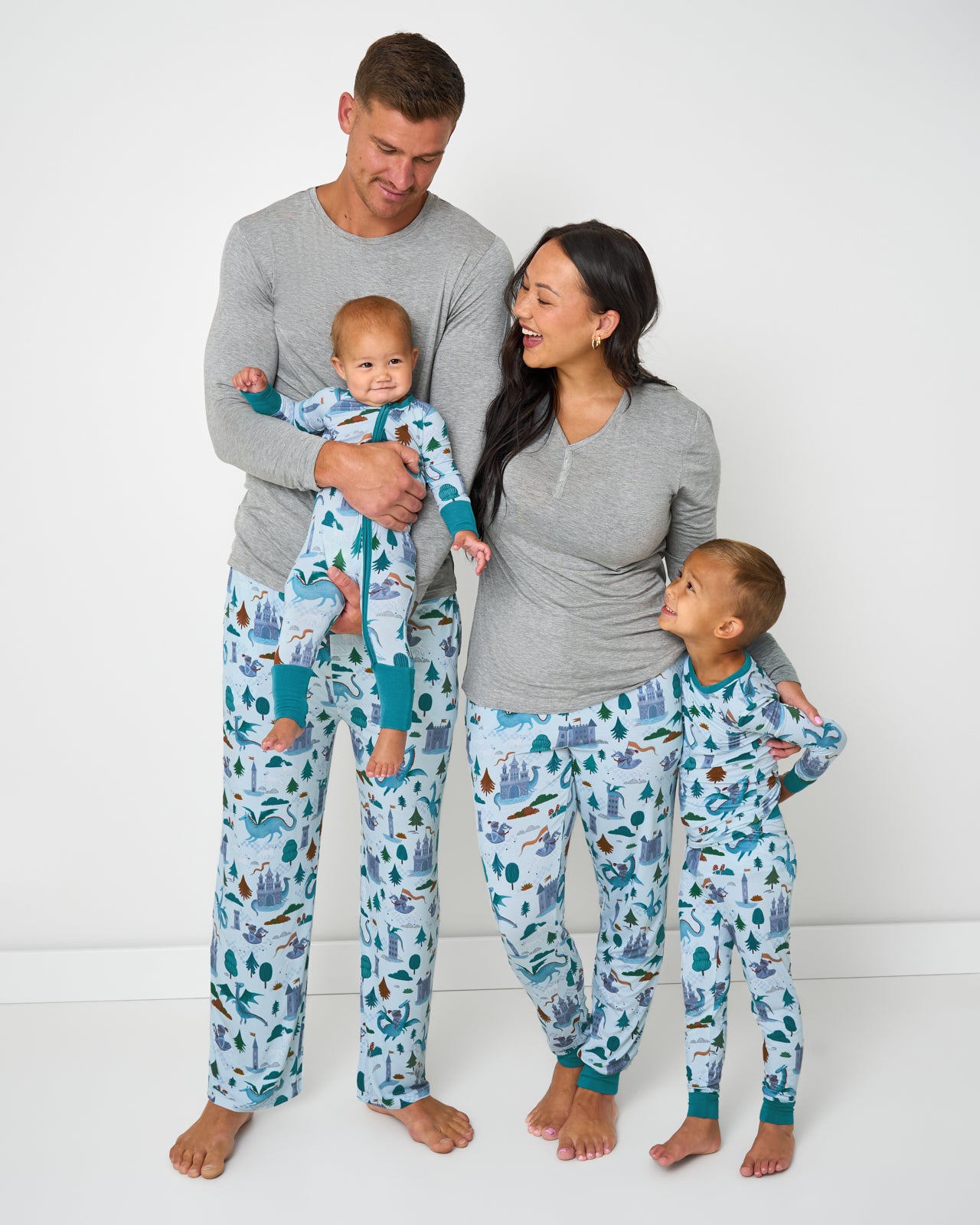 Family of four wearing matching Knight's Quest pajamas