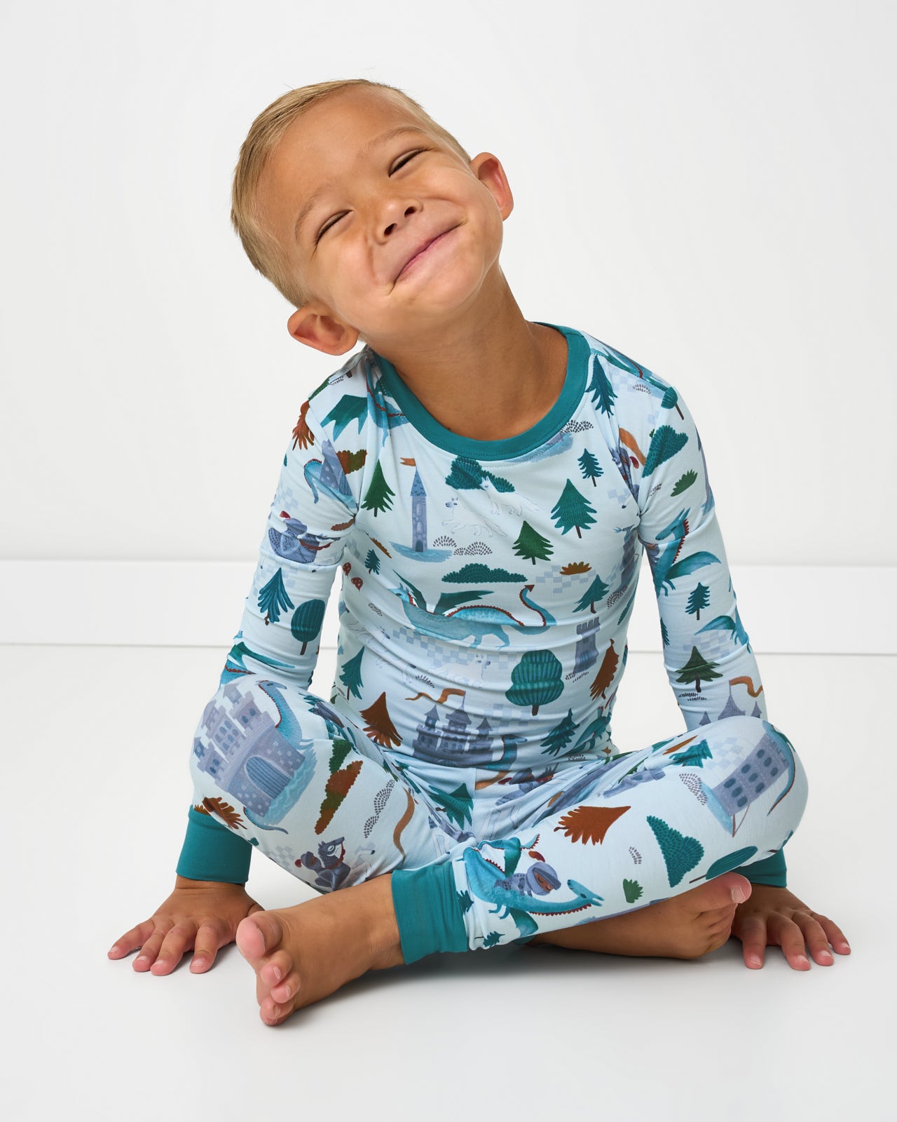 Sitting boy wearing the Knight's Quest Two-Piece Pajama Set