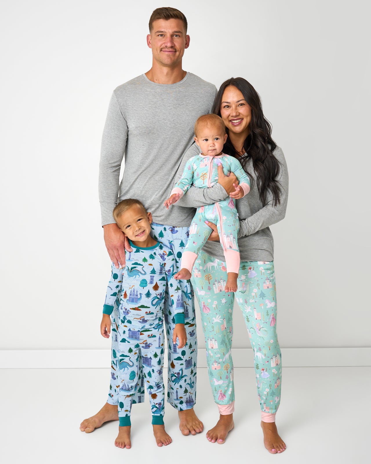 Family of four wearing matching Enchanted Fairytale and Knights Quest Pajamas