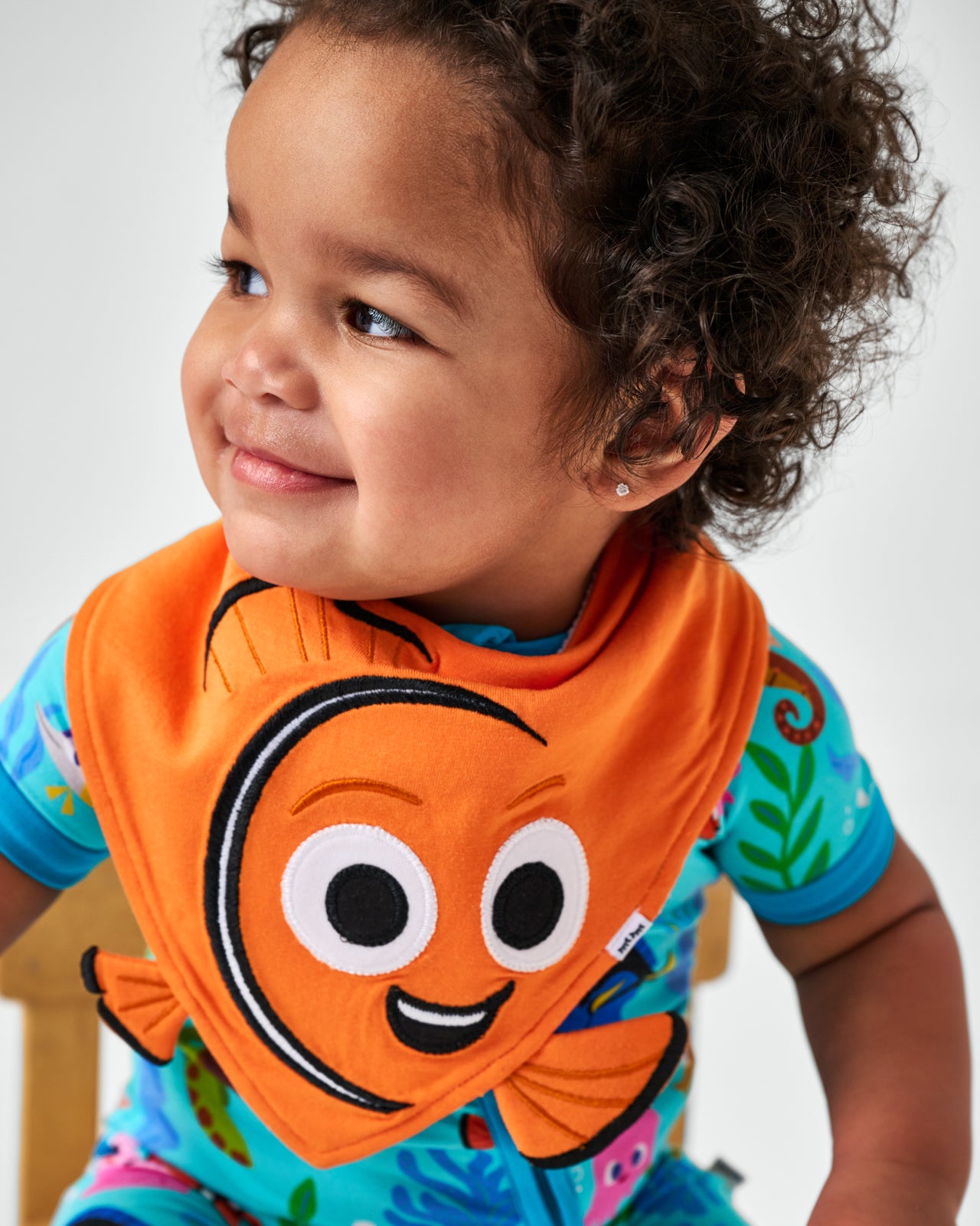 Close up of child wearing the Disney Nemo Bandana Bib