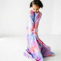 Alternate image of a child wrapped up in a Pastel Tie Dye Dreams large cloud blanket wearing matching pajamas