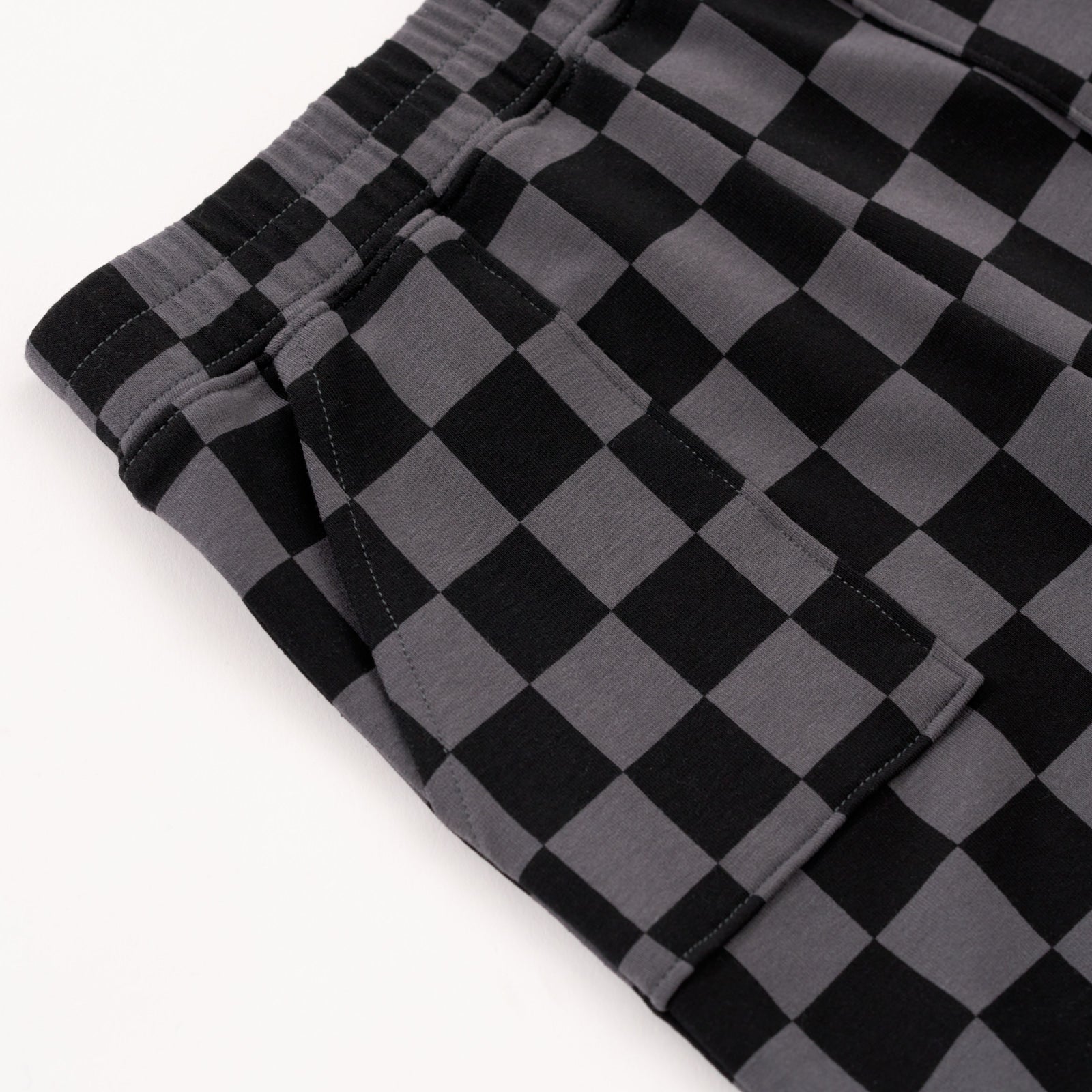 Close up flat lay of the waist and pocket detail on the Monochrome Checks Shorts