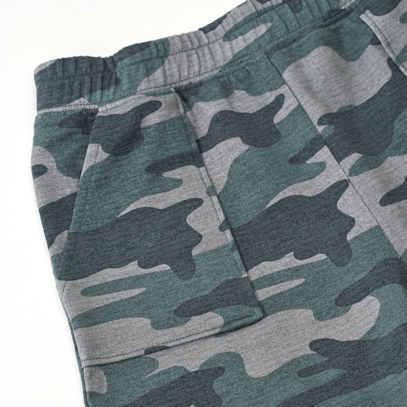 Close up flat lay of the waist and side pocket detail on the Vintage Camo Shorts