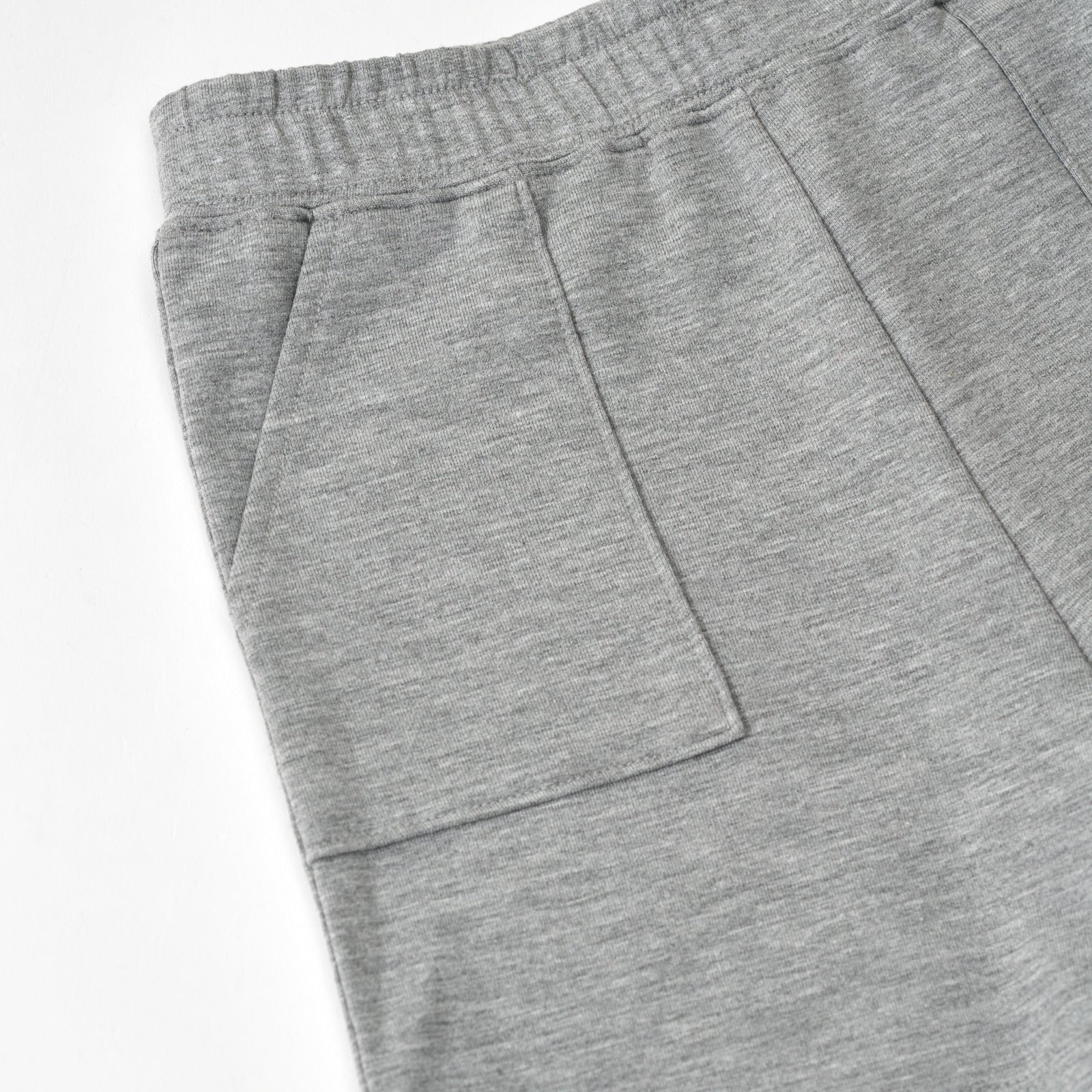 Close up flat lay image of the pocket detail on the Heather Gray Shorts