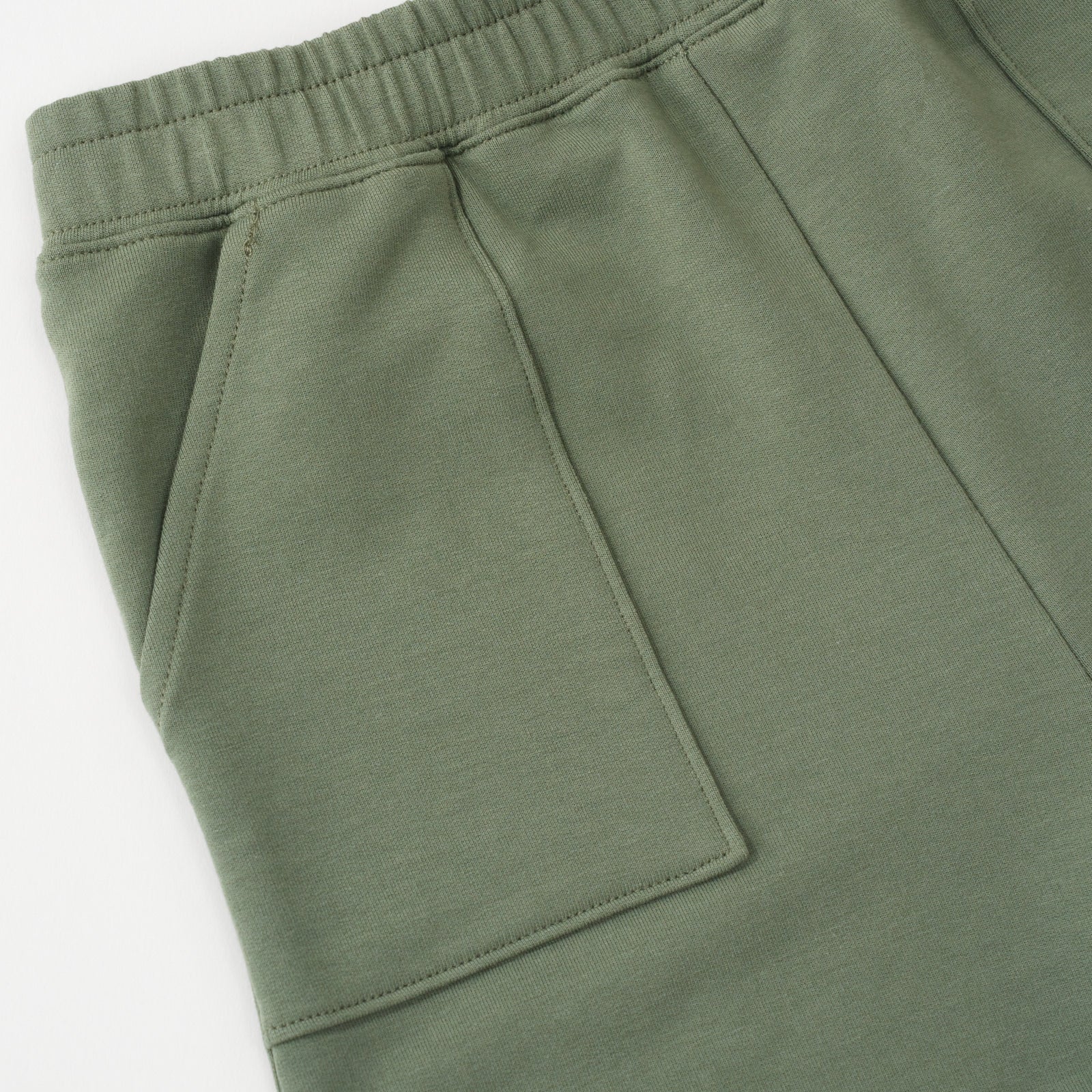 Close up flat lay of the side pocket and waist details on the Moss Shorts