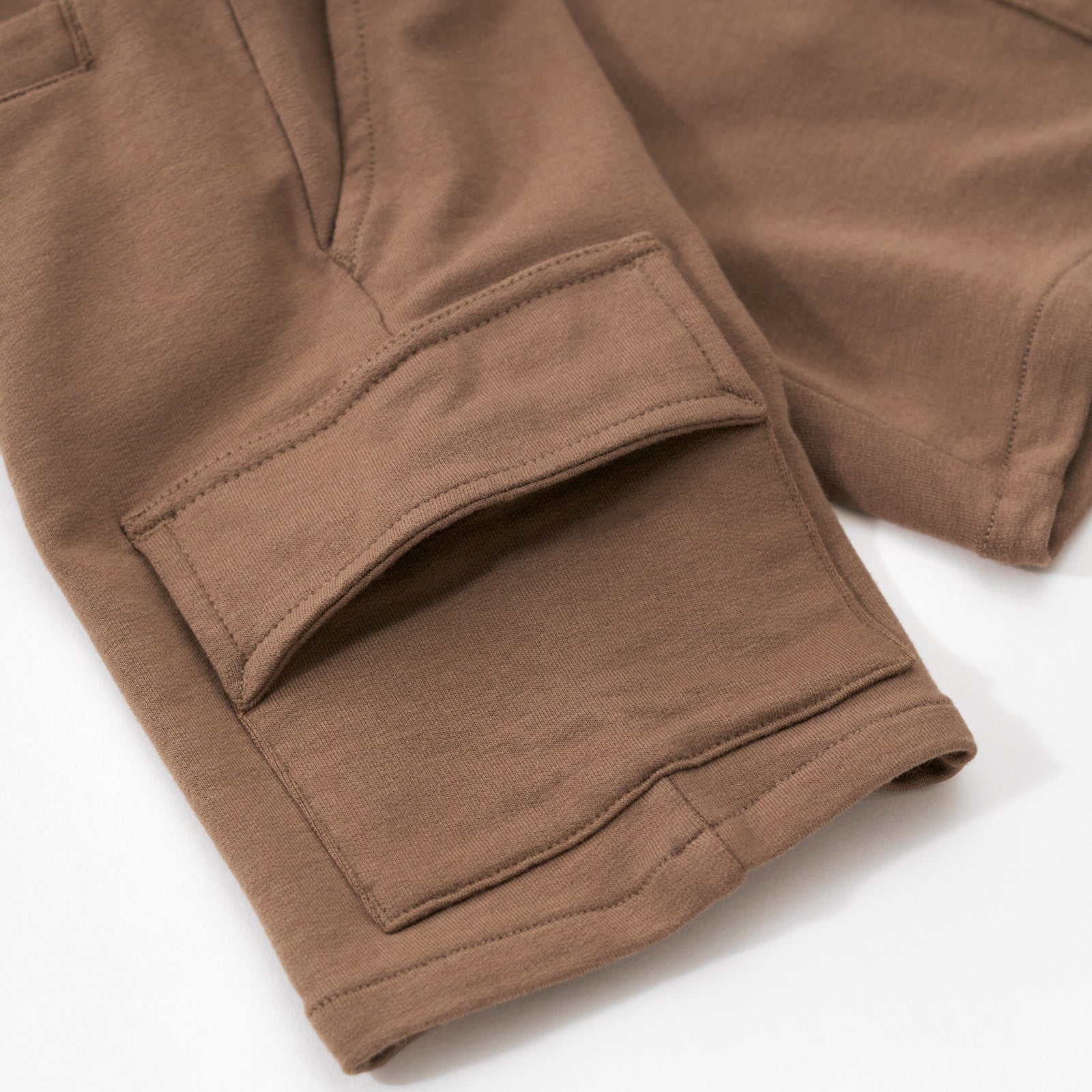 Close up flat lay image of the side cargo pocket detail on the Vintage Brown Cargo Shorts