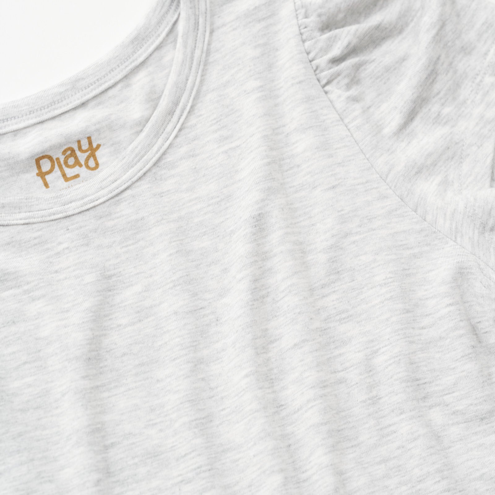 Close up flat lay of the sleeve detail on the Light Heather Gray Puff Sleeve Tee