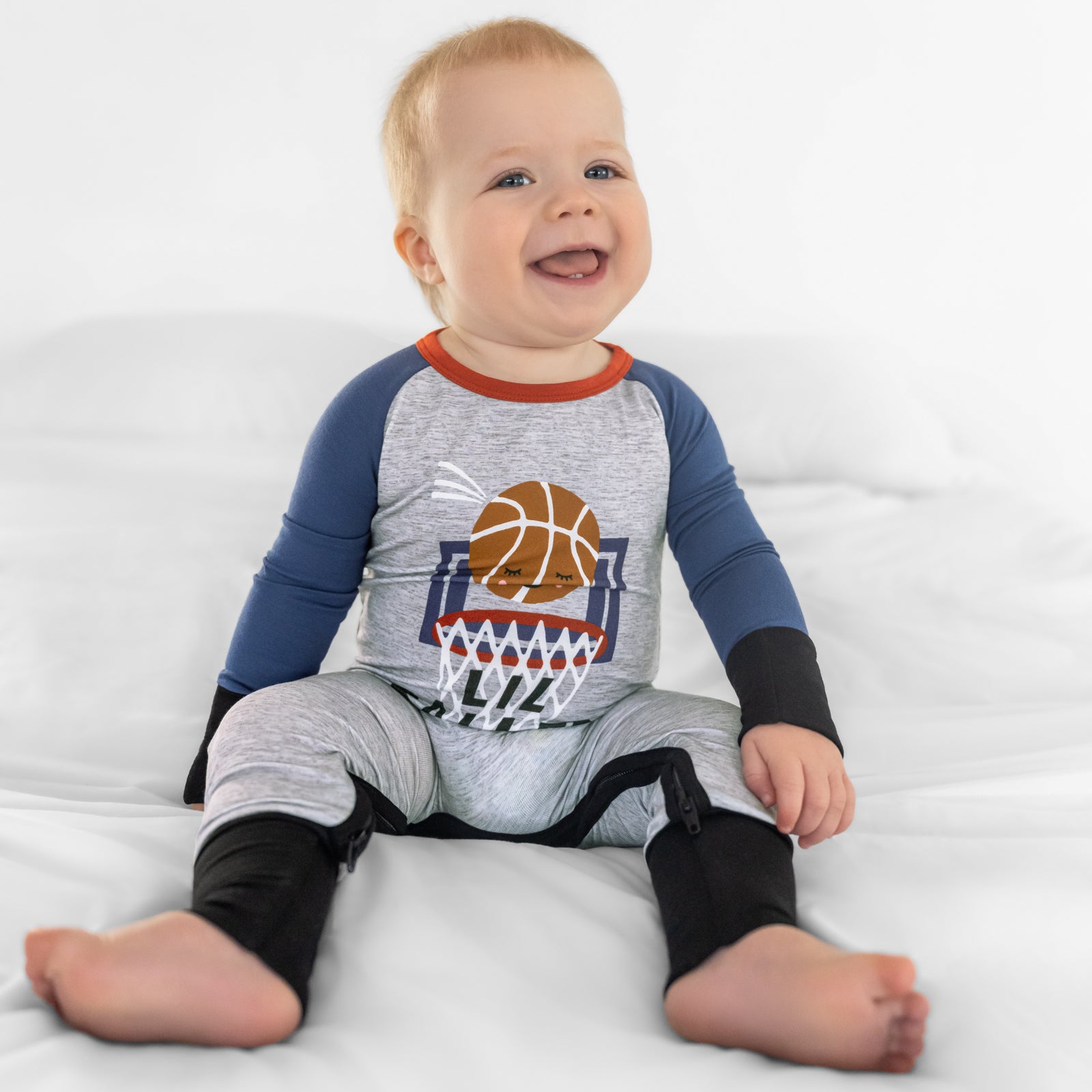 Sitting child wearing the Slam Dunk Graphic crescent zippy