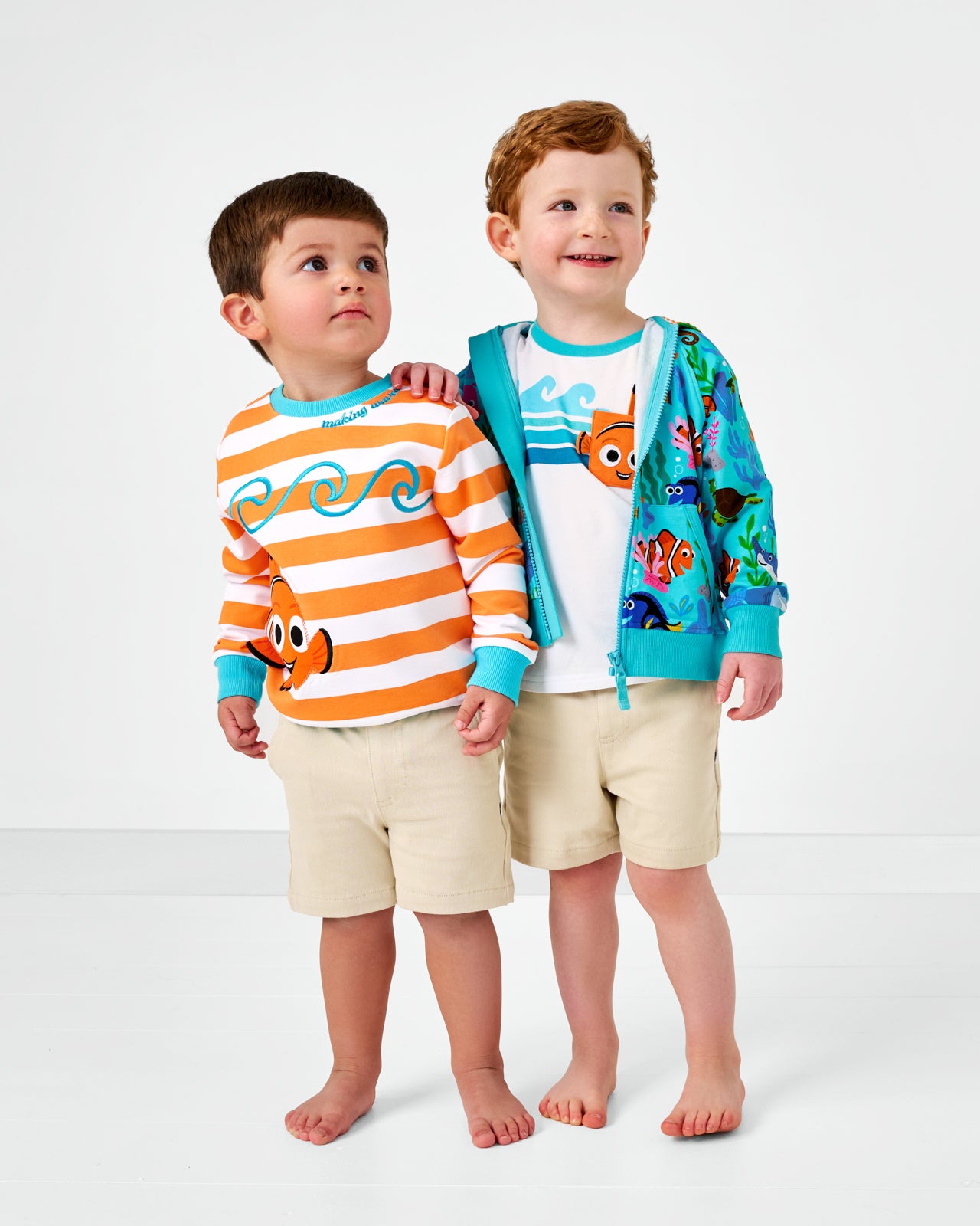 Two children wearing Finding Nemo styles with light khaki shorts