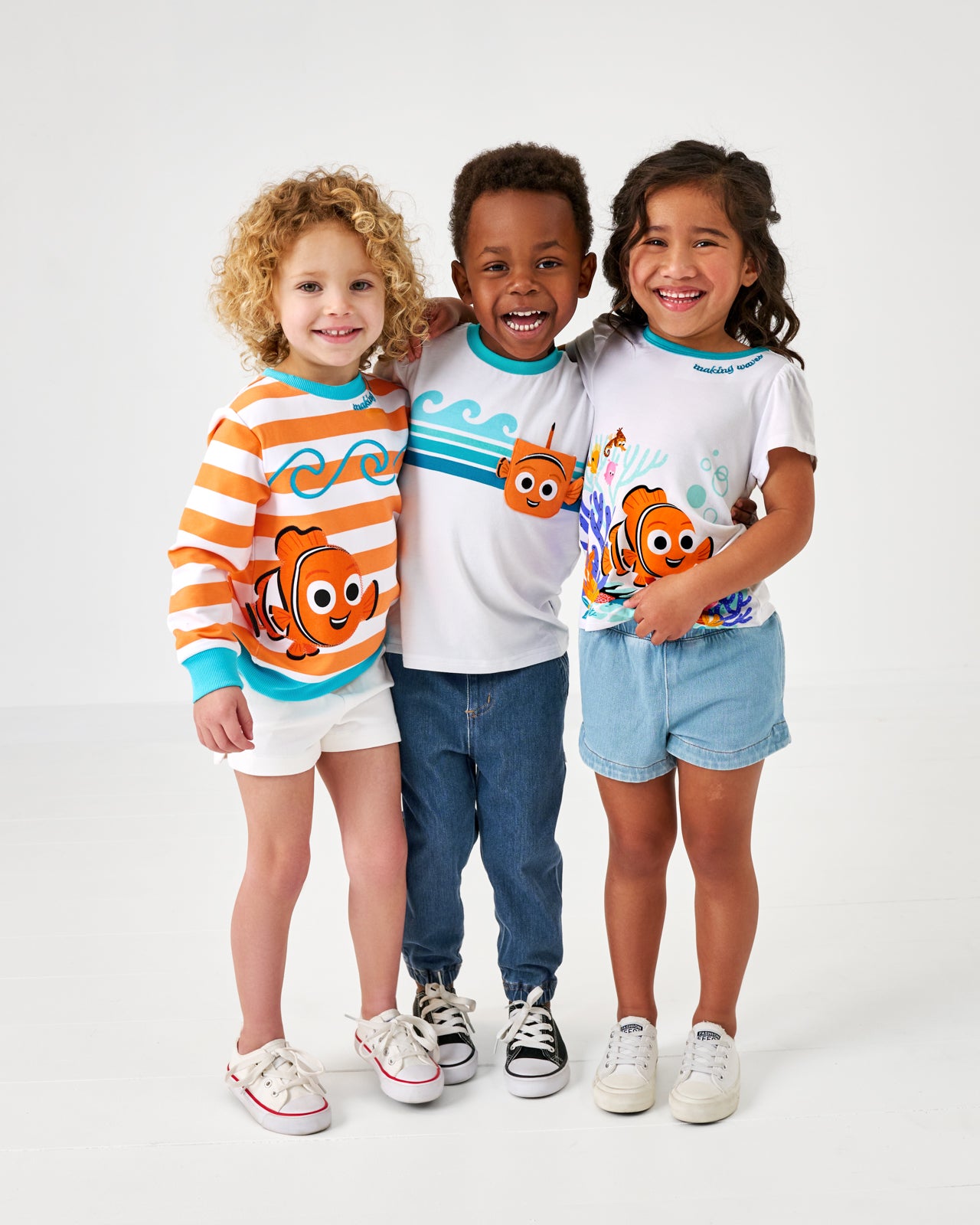 Three children wearing matching Finding Nemo tops from the Disney Swimming with Nemo collection