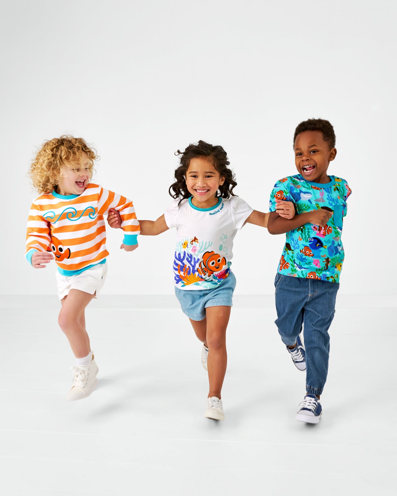 Three running children wearing play styles from the Disney Swimming with Nemo collection