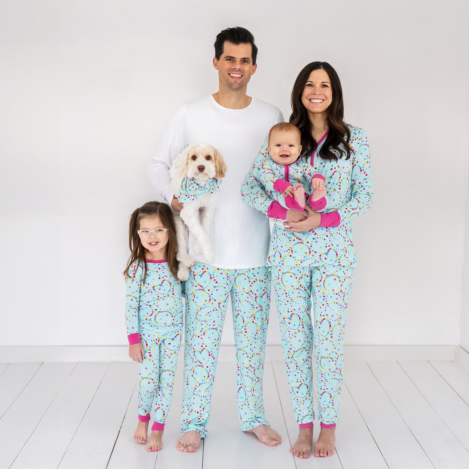 Family of four and their dog wearing matching Friends Forever bamboo pajamas
