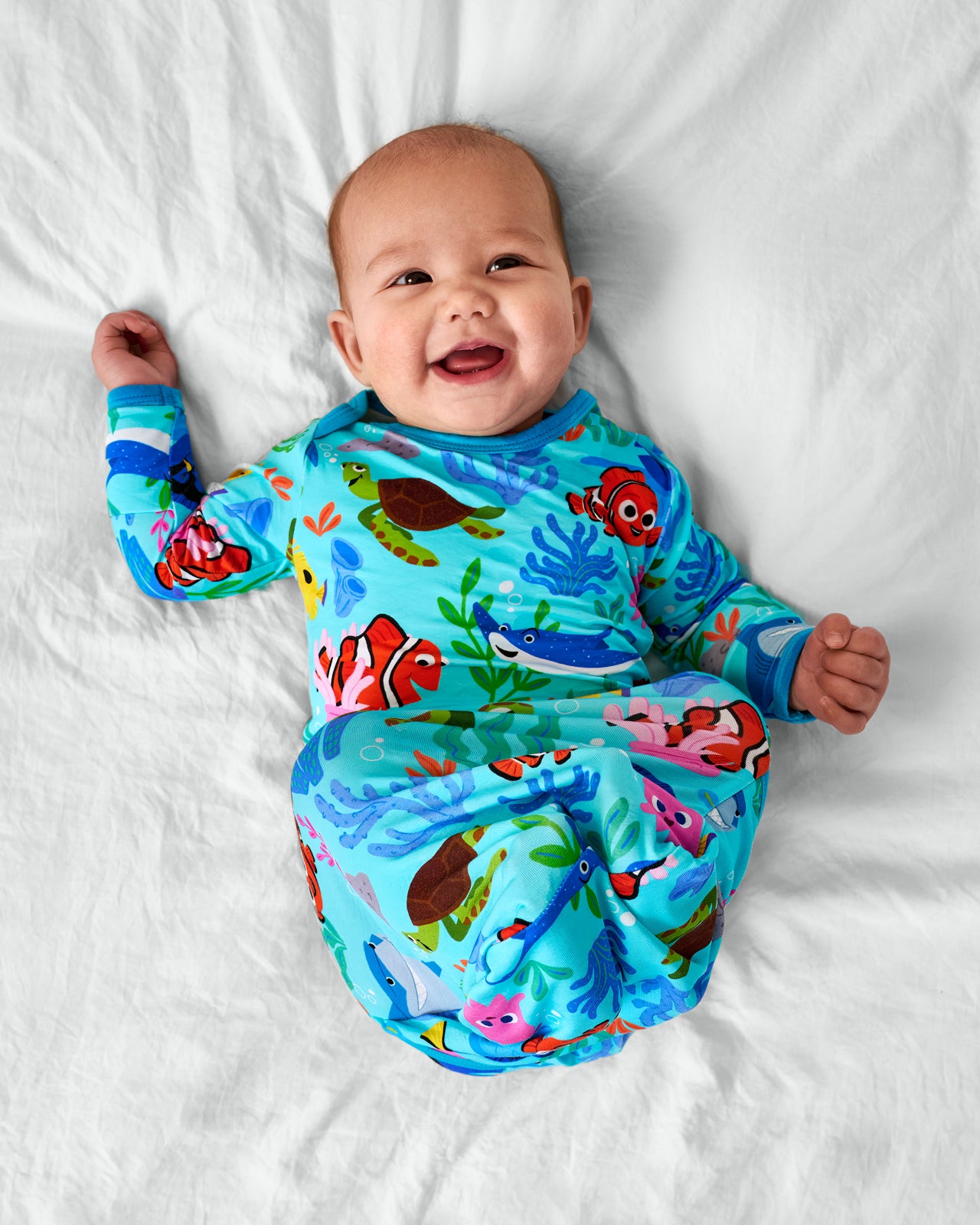 Smiling baby wearing the Disney Nemo's Reef Infant bamboo Gown