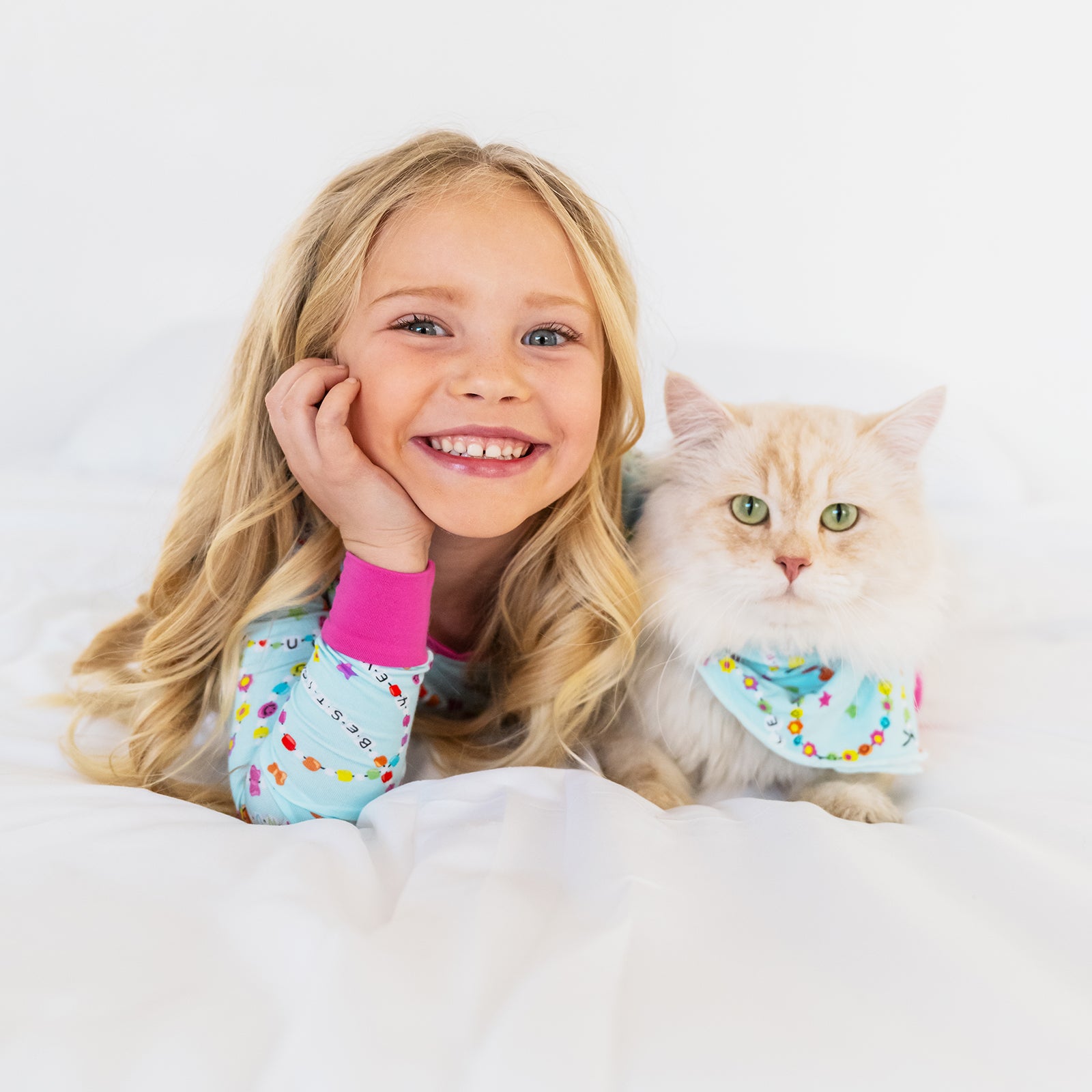 Girl and cat wearing matching Friends Forever sleep styles