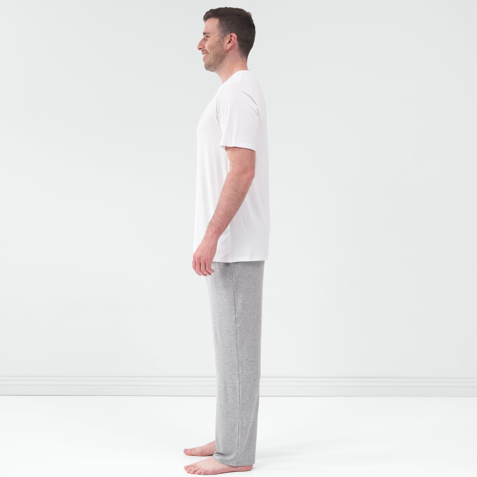 Side view of man wearing the Heather Gray Men's Pajama Pants with a white pajama top