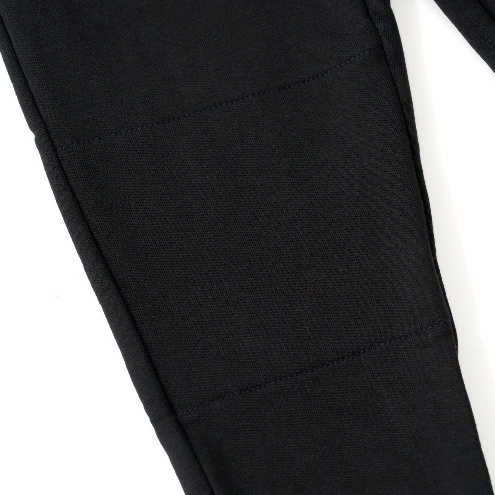 Close up of the knee detail on the Black Play Jogger