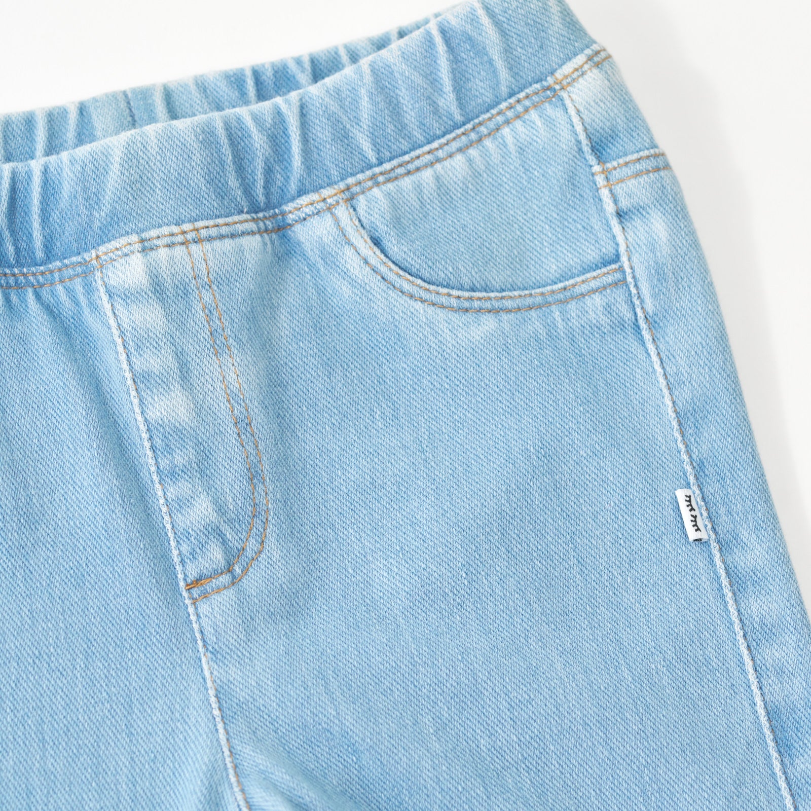 Close up flat lay image of the waist and pocket detail on the Light Blue Denim Jegging
