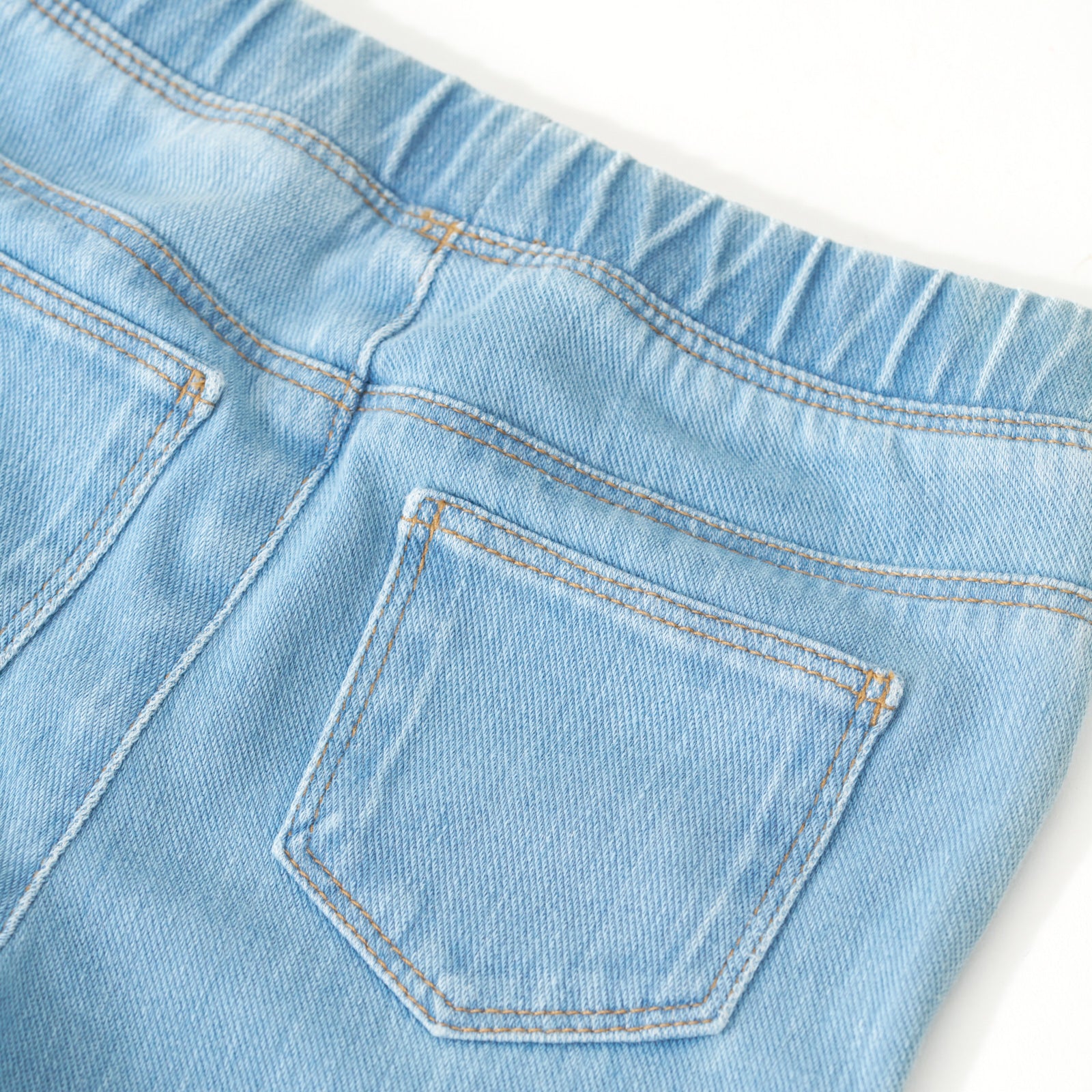 Flat lay image of the back of the Light Blue Denim Jegging