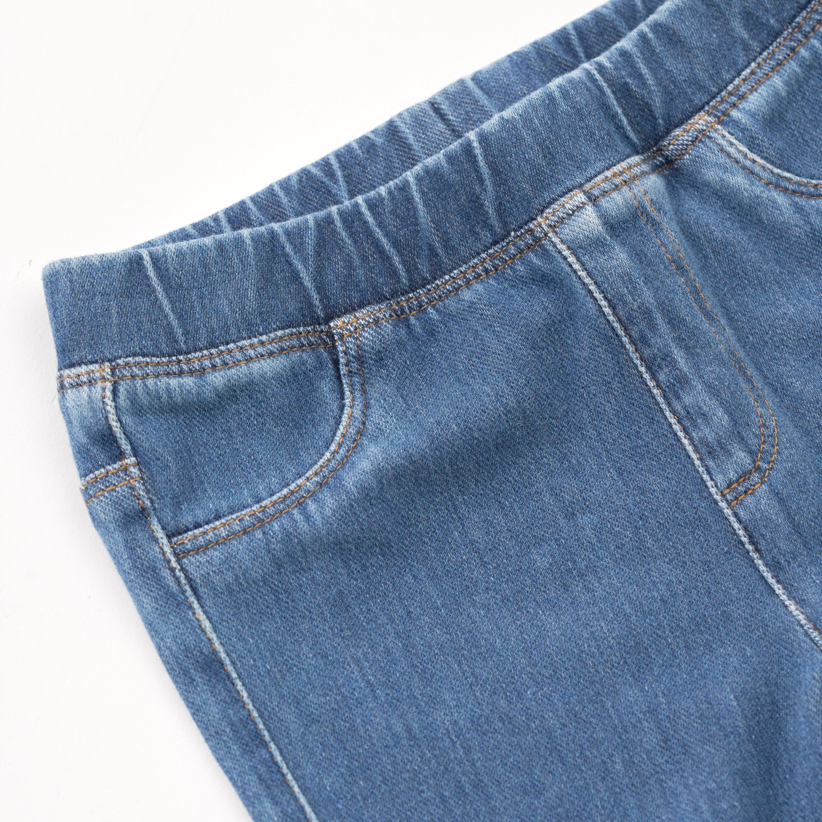 Close up image of the waist detail on the Midwash Blue Denim Jegging