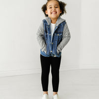 Child wearing a Midwash Blue Denim jacket and coordinating Play outfit with her hands in her pockets