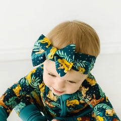Close up image of a child wearing a Disney Simba's Sky luxe bow headband