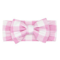 Flat lay image of a pink gingham luxe bow headband in size newborn to age four