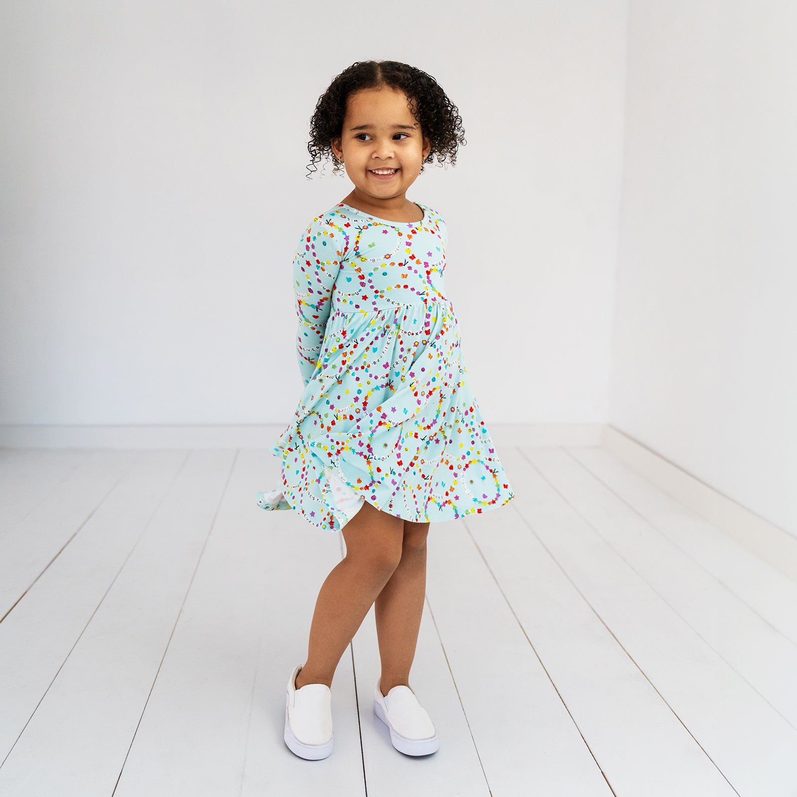 Twirling child wearing the Friends Forever Twirl Dress