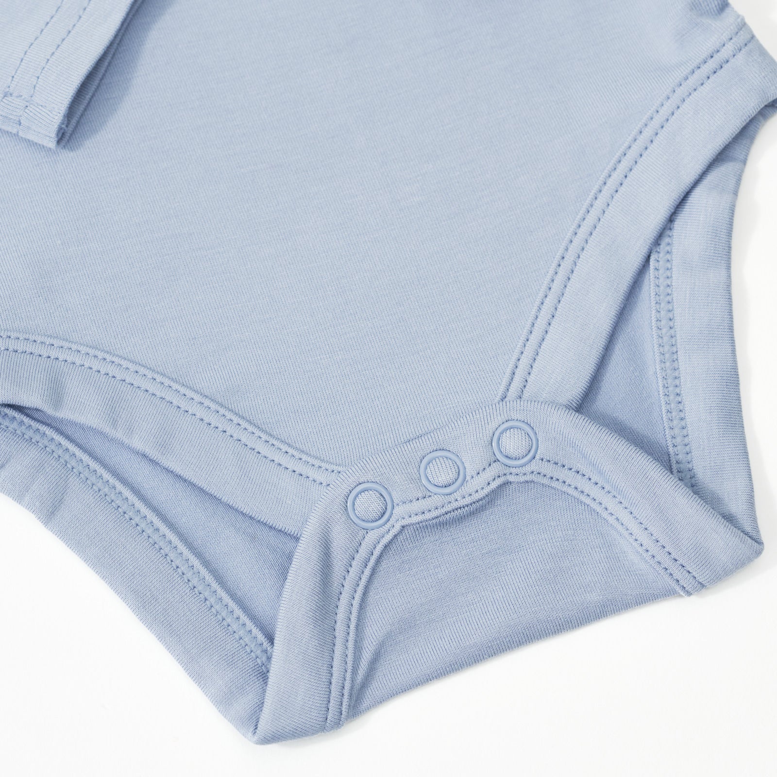 Close up image of the snap details for the Fog Bodysuit