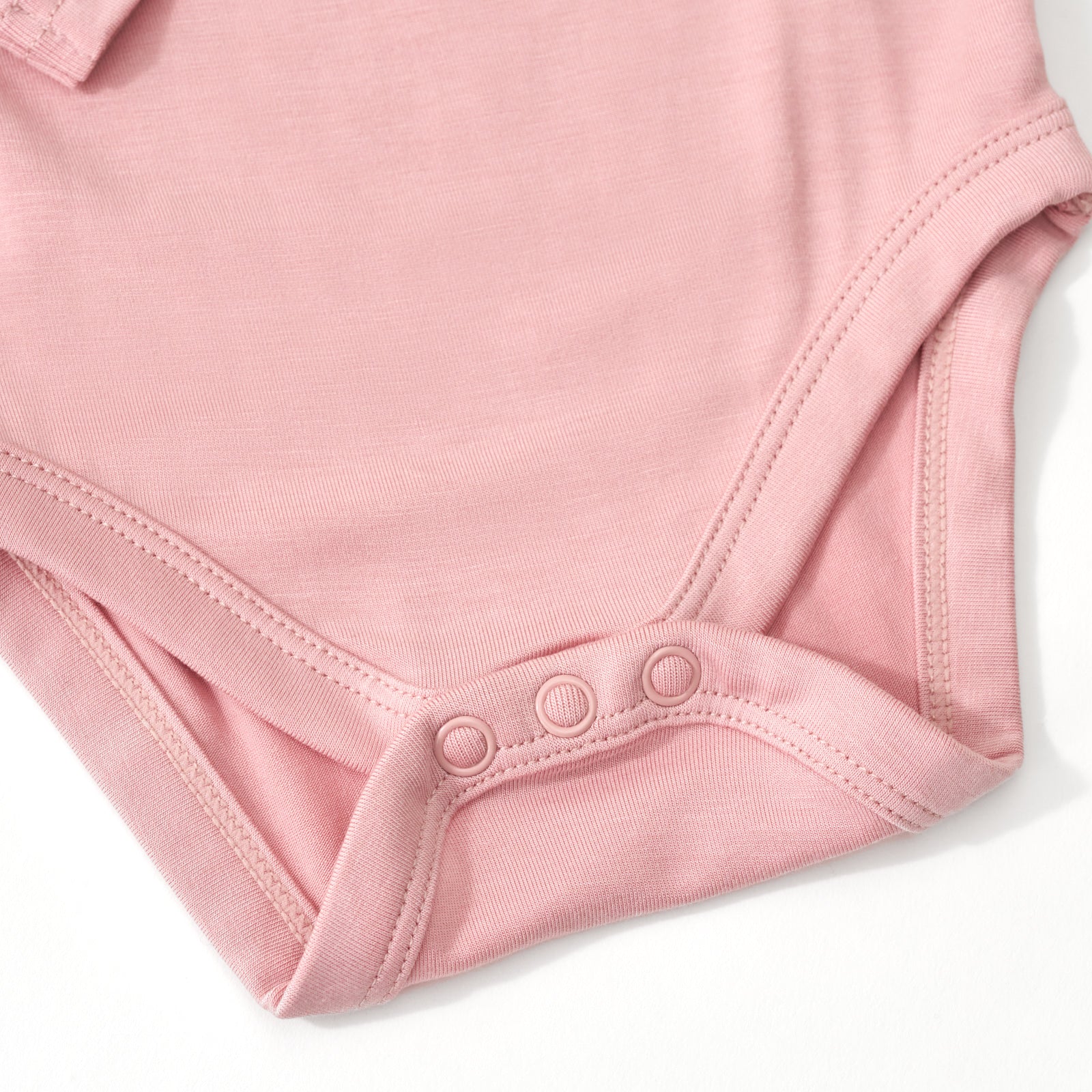 Close up of the snap detail on the Mauve Blush Bodysuit