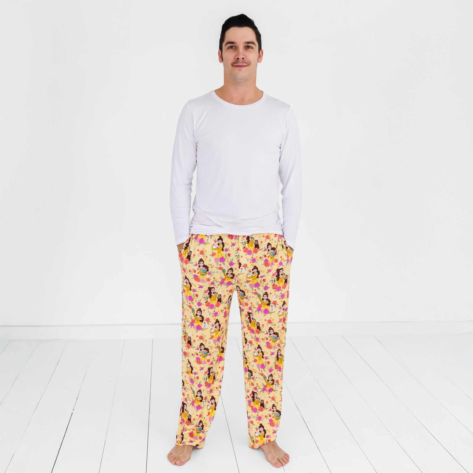 Standing man wearing the Disney Princess Belle Men's Pajama Pants and white long sleeve pajama top