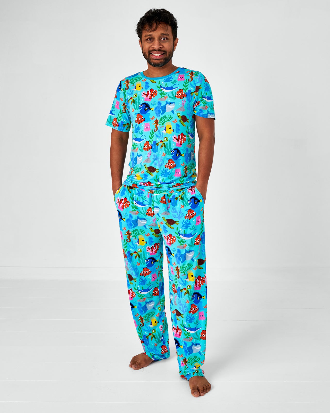 Standing man wearing the Disney Nemo's Reef Men's Pajama Pants and matching bamboo pajama top