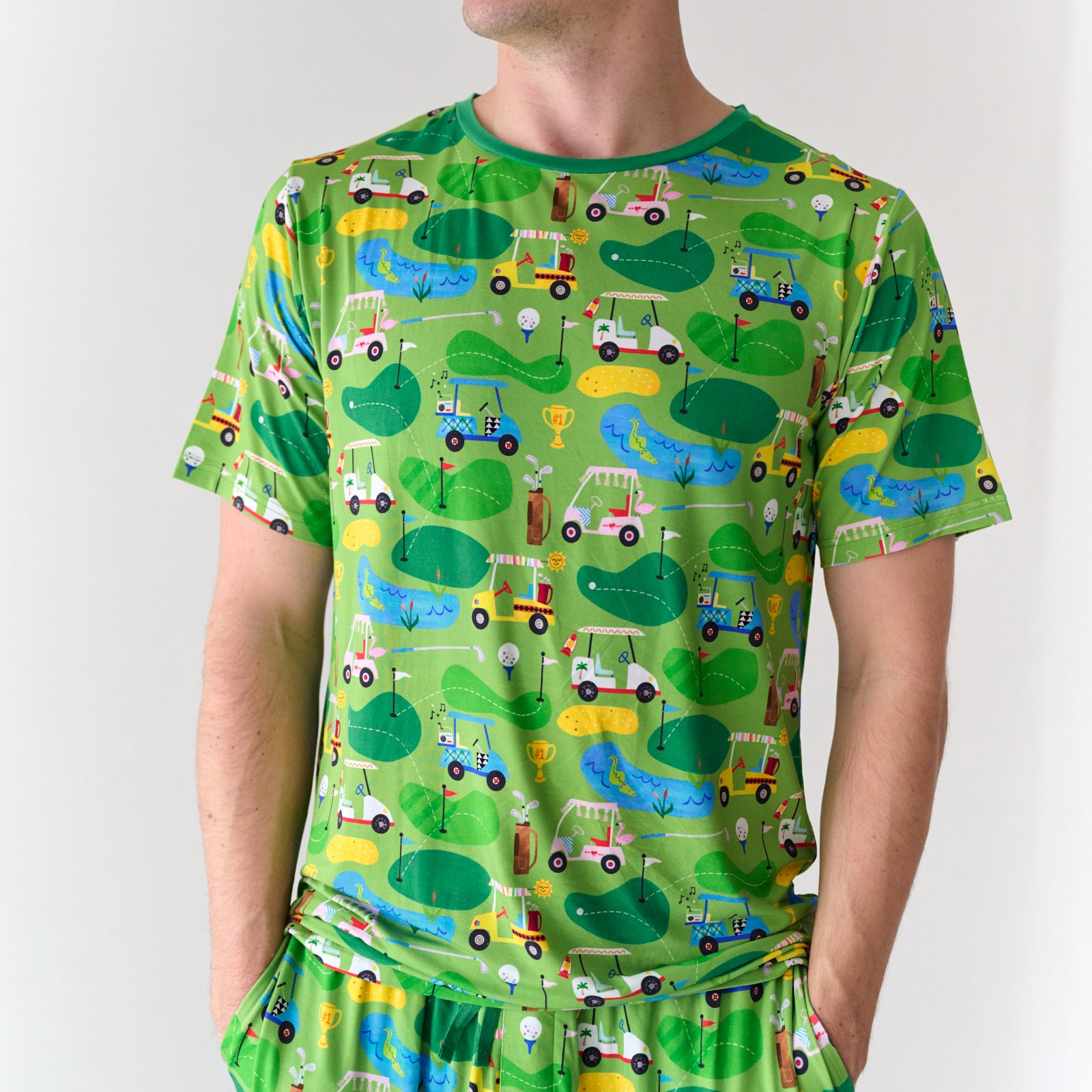 Close up image of a man wearing a Fairway Fun men's short sleeve pajama top and matching pajama pants
