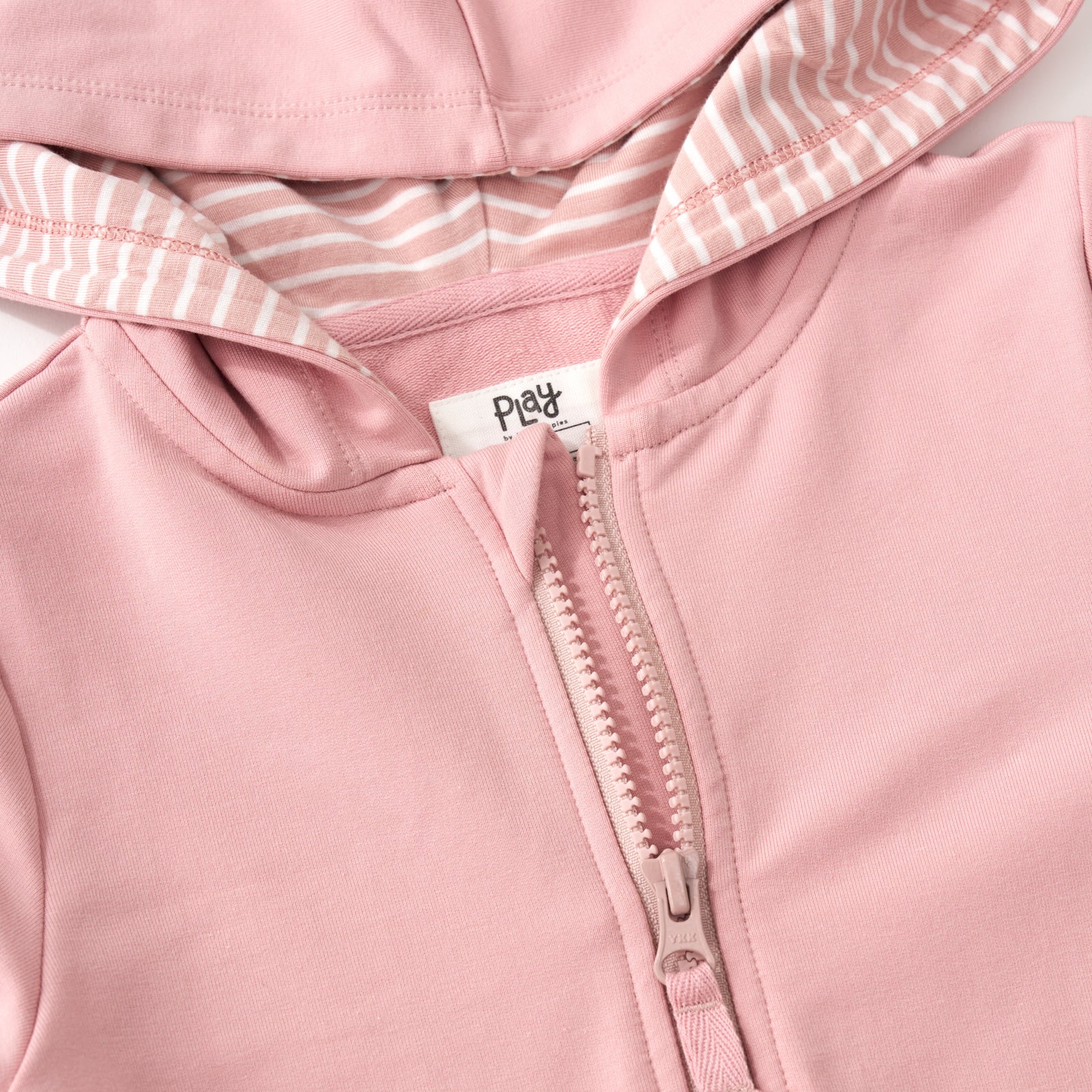 Close up of the zipper detail for the Mauve Blush Peplum Hoodie