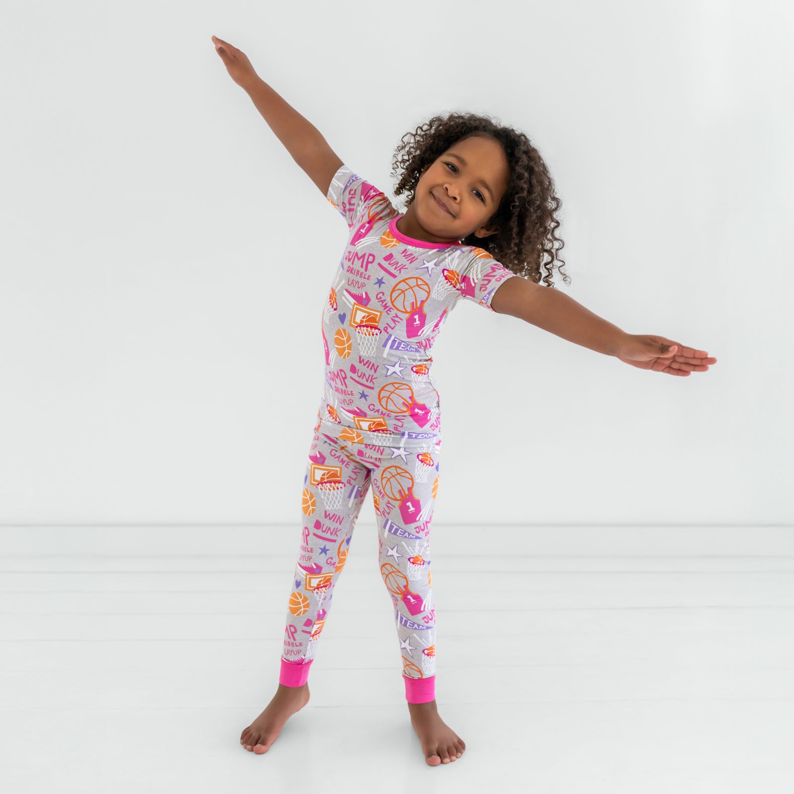 Dancing child wearing the Pink Slam Dunk short sleeve pajama set