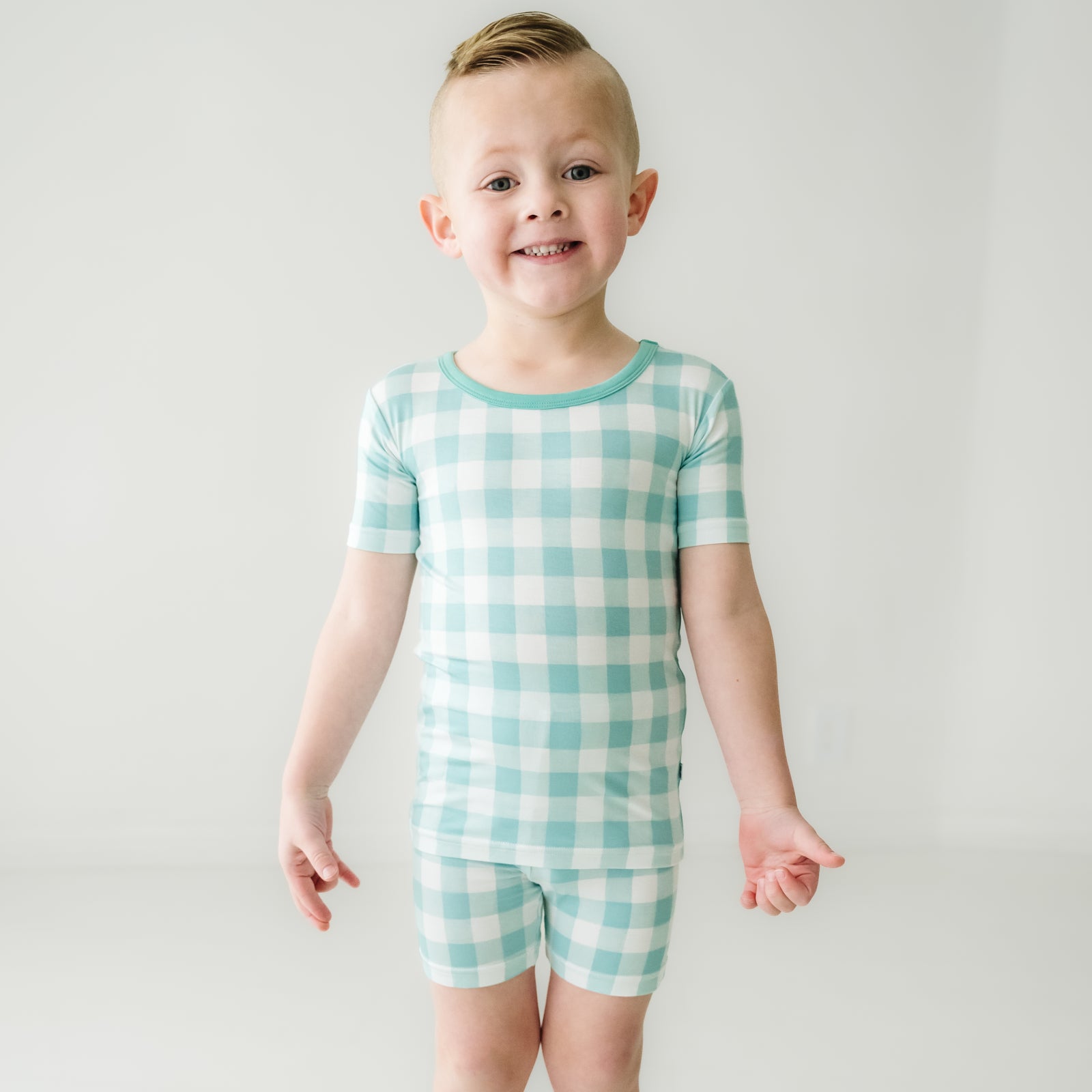 Alternate image of a child posing wearing a Aqua Gingham two piece short sleeve and shorts pajama set