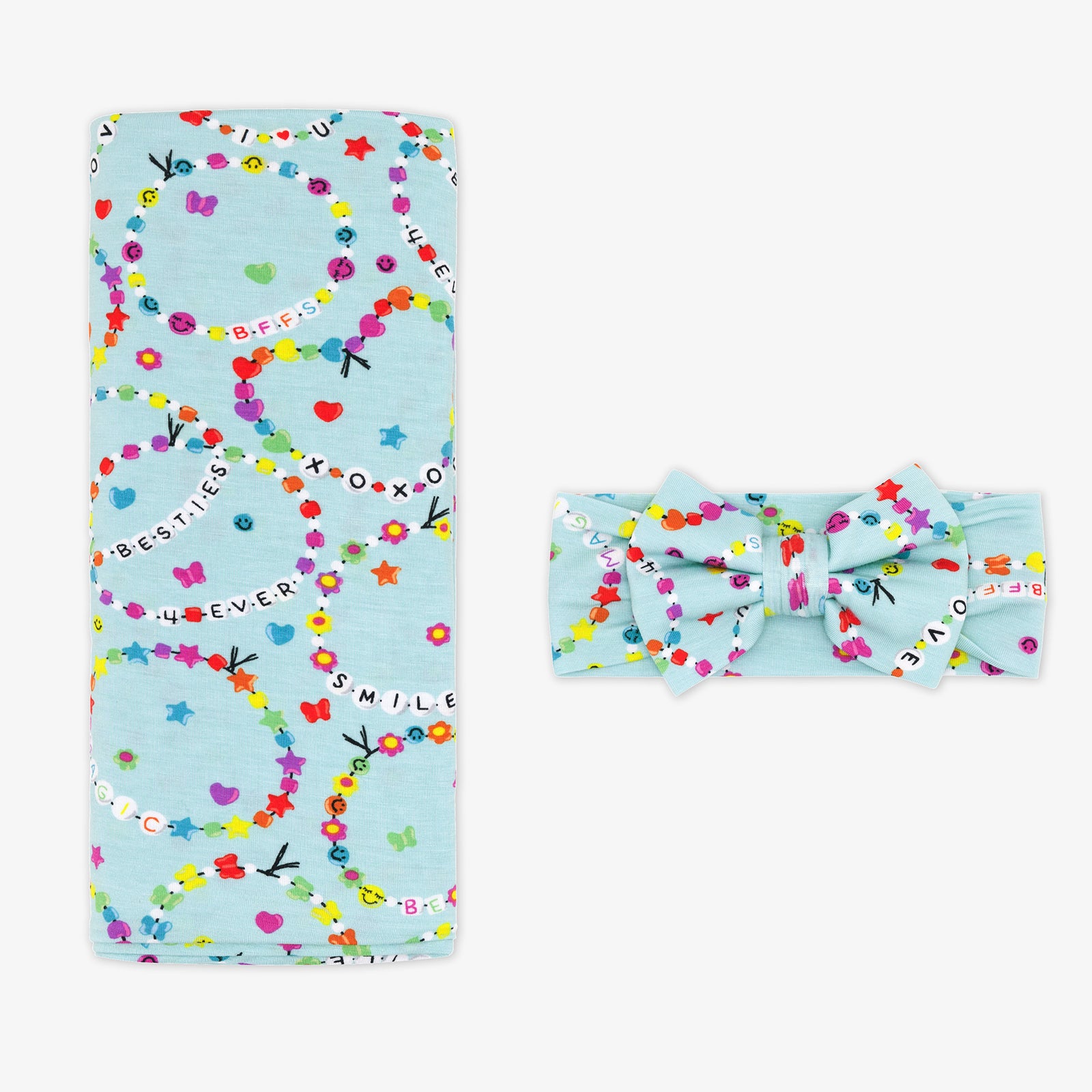 Flay lay image of a Friends Forever swaddle and bow set