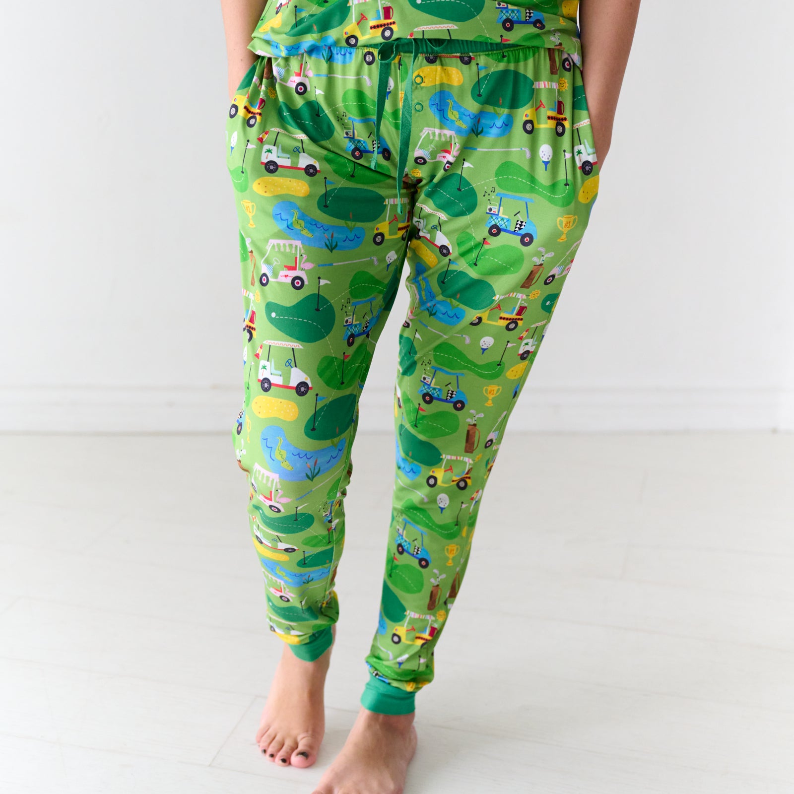 Close up image of a woman wearing Fairway Fun women's pajama pants and matching pajama top