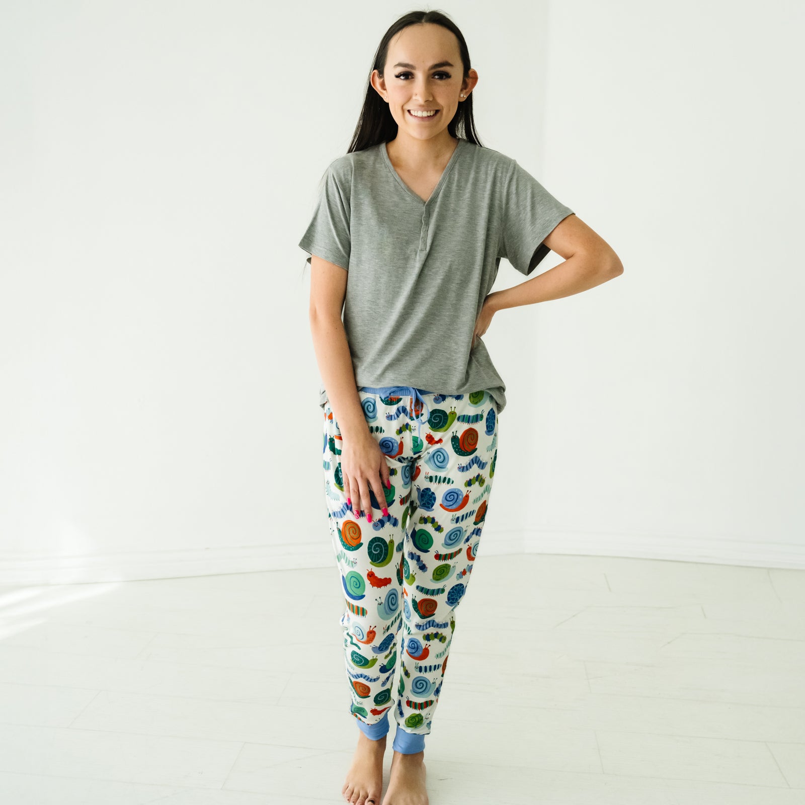 Woman wearing a Heather Gray women's short sleeve pajama top and coordinating pajama pants